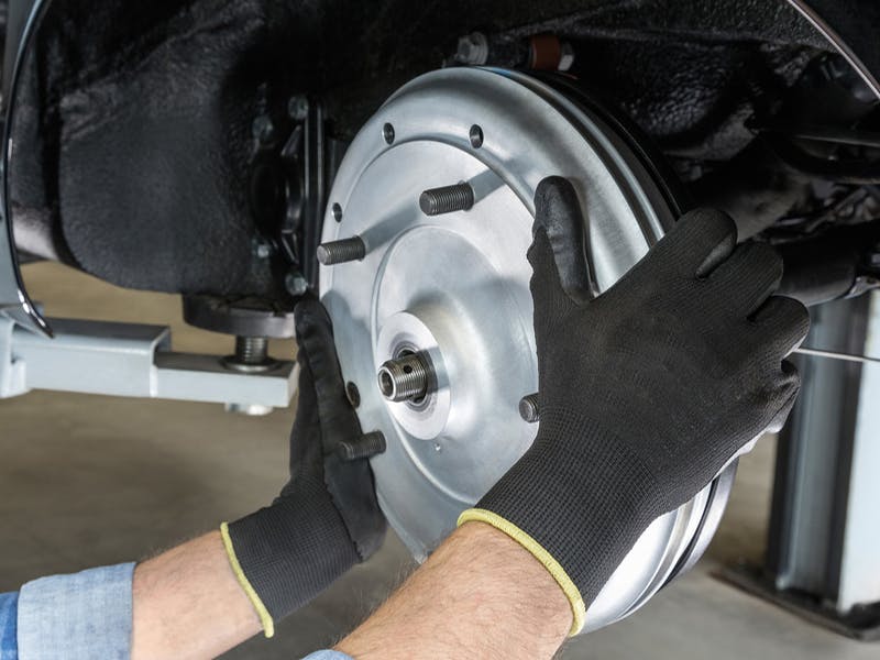 Detail: 356 A brake drum, hands with work gloves.