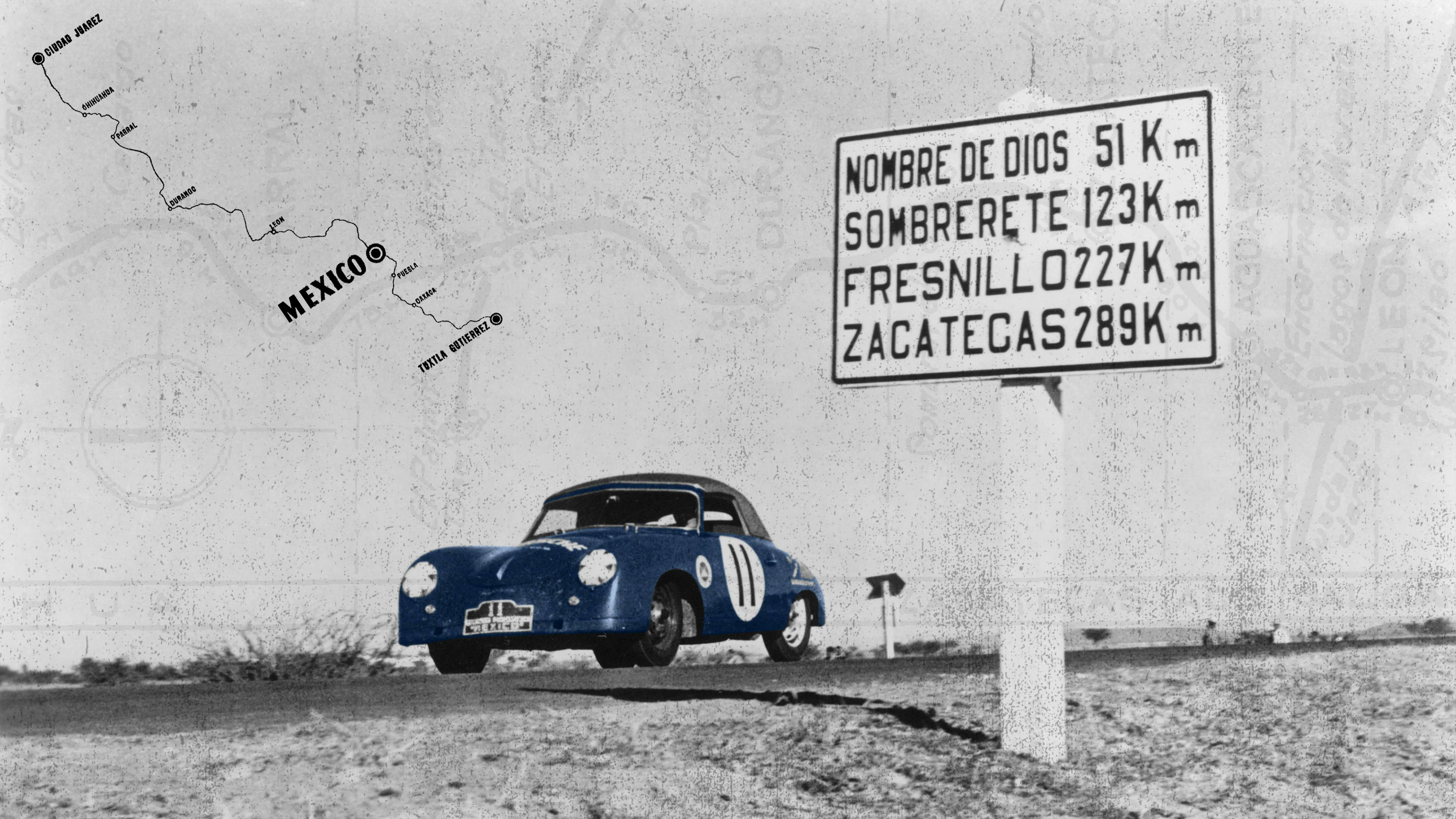 Black and white image from 1952 of a Porsche 356 SC Cabriolet in front of a road sign.
