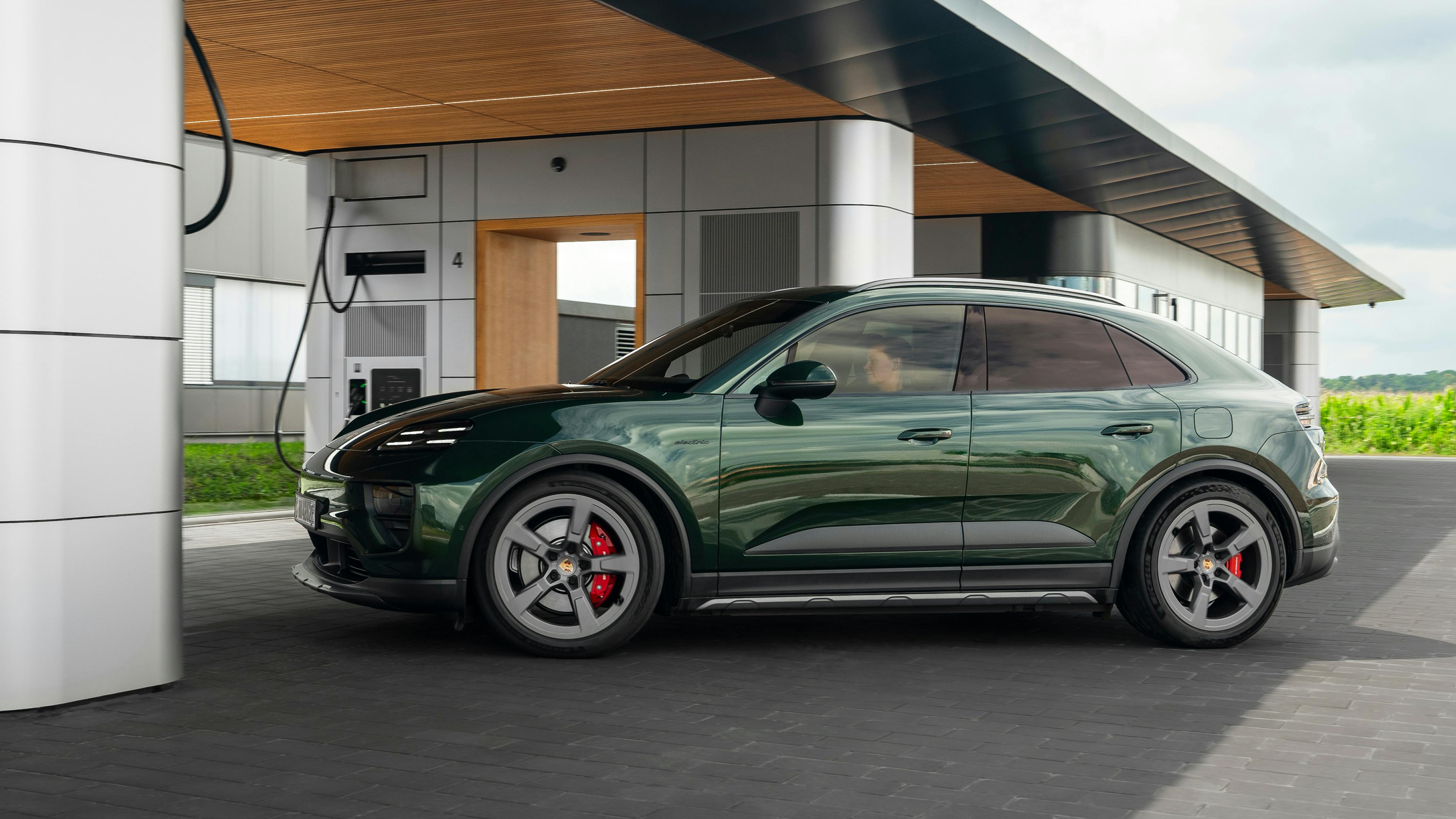 A Porsche Macan 4S stopping at a Porsche Charging Lounge. Side view of the vehicle.