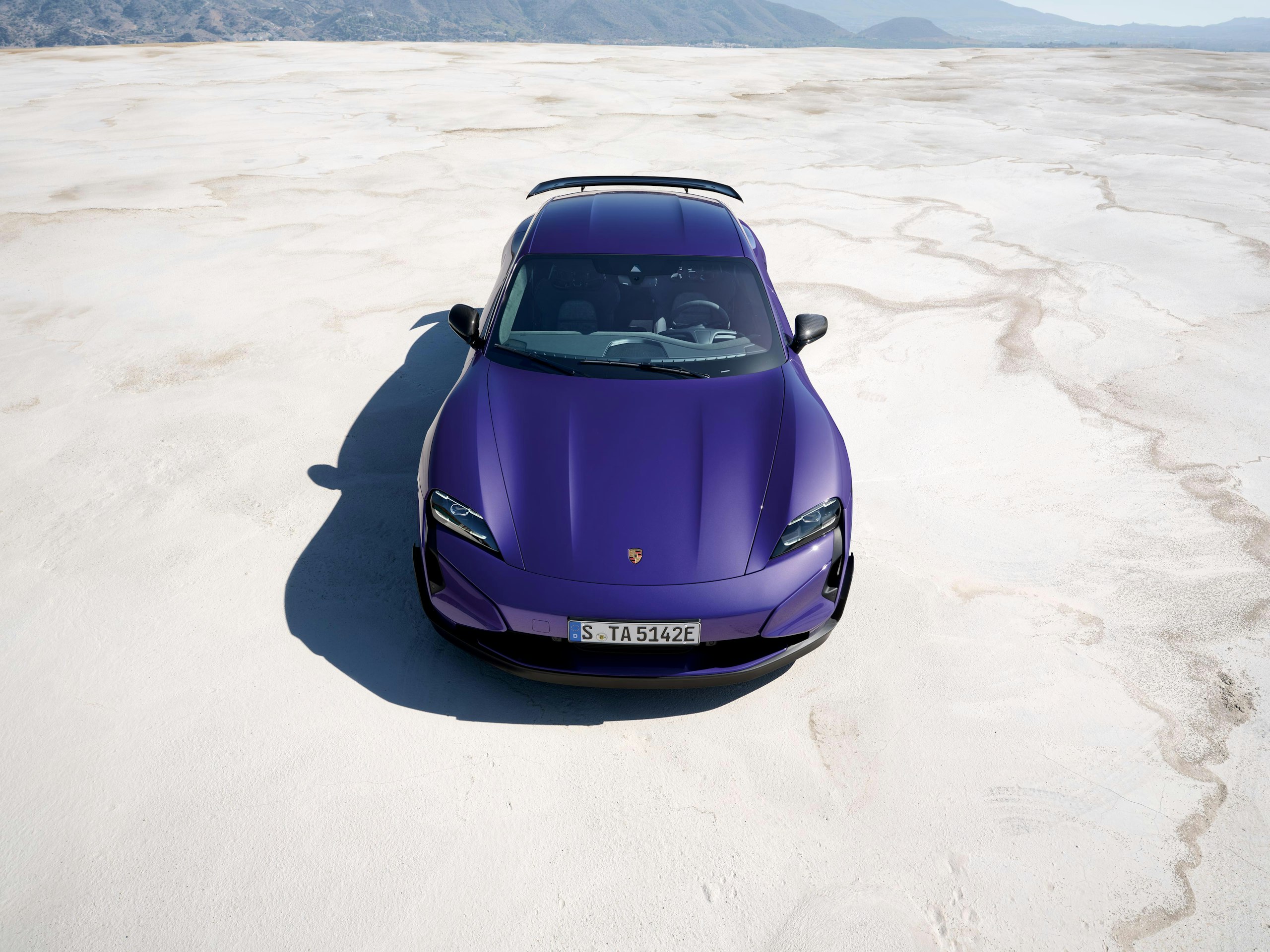 Shot of a purplesky metallic Taycan Turbo GT with Weissach package parked in a salt desert.