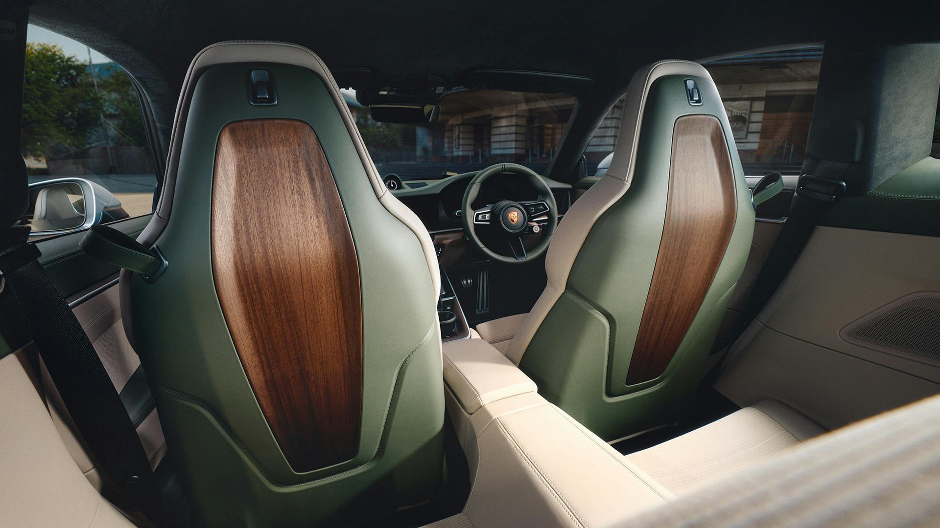 Rear view of the front sports seats in the Earls Court 51 Edition, trimmed in green leather with contrasting wood-grain backrests.​
