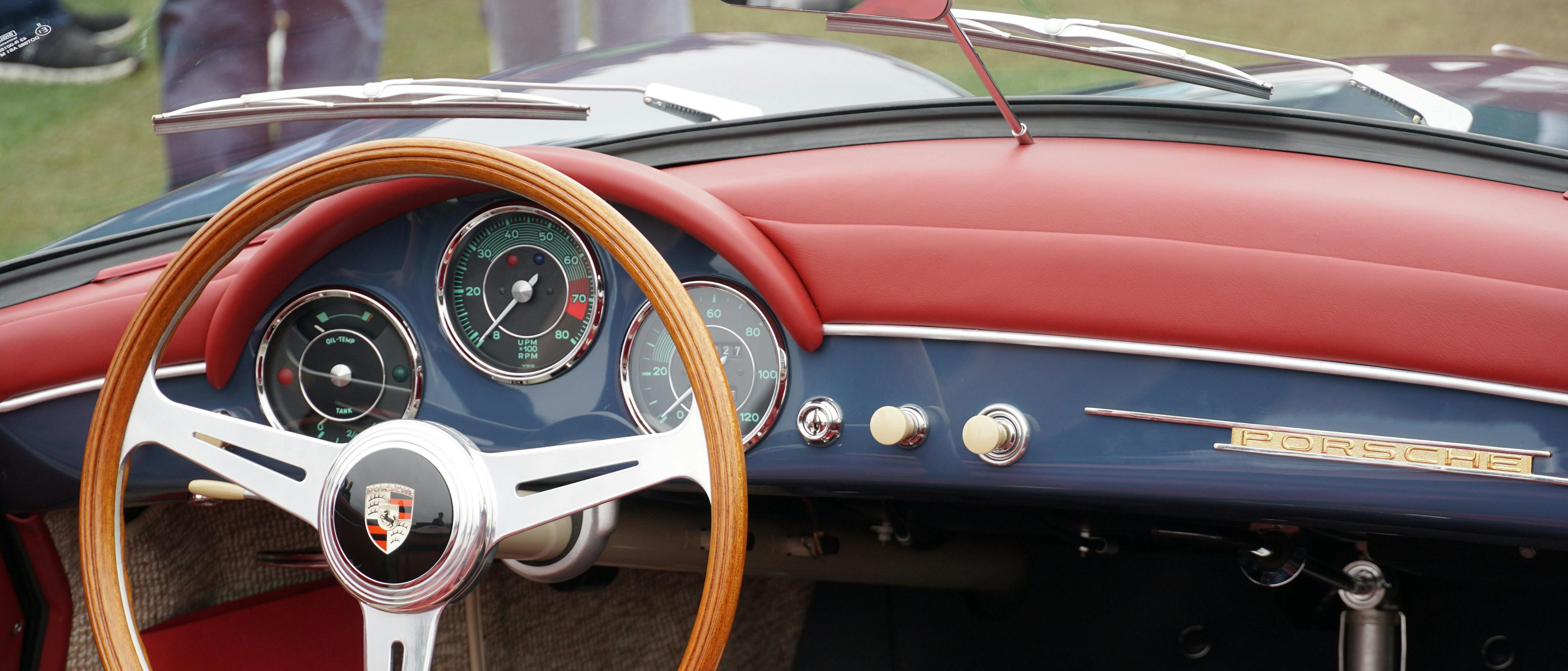 Interior view of a Porsche 356 Cabriolet showcasing the steering wheel and dash components.