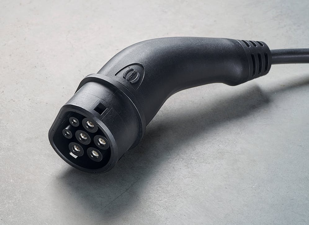 A type 2 charging plug on a grey background.