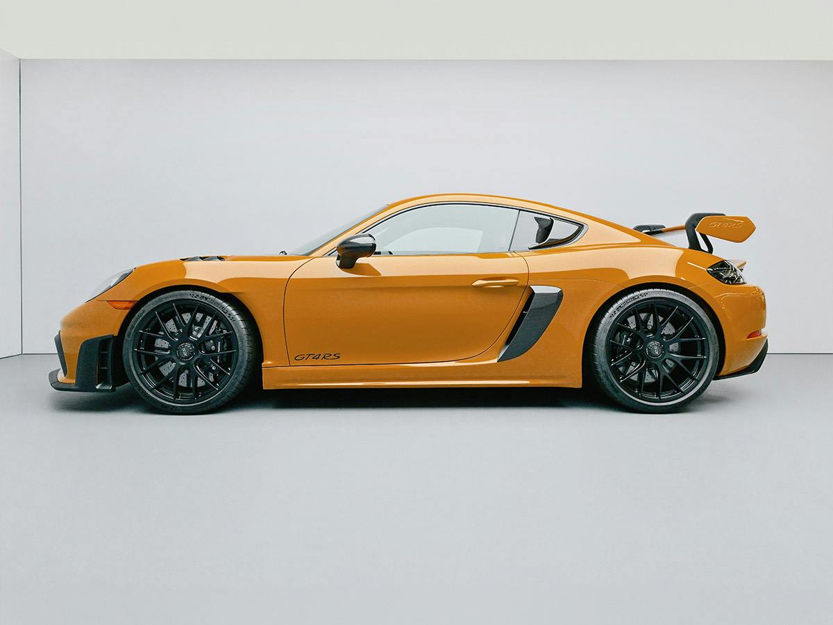 A Porsche 718 Cayman GT4 RS in Paint to Sample colour Bahamayellow, shown from the left side view in a white studio.