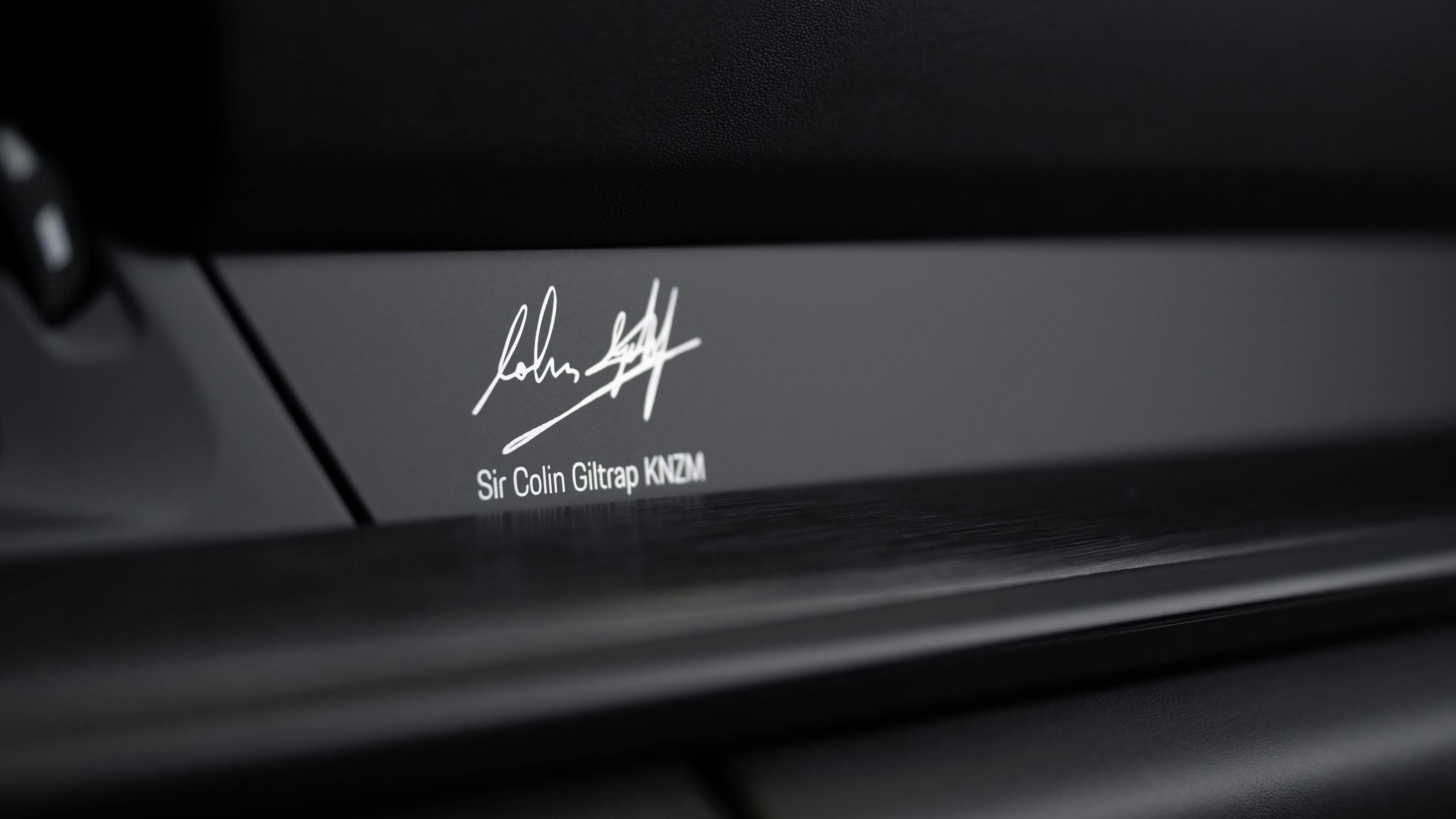 Close-up of a car interior trim panel displaying Sir Colin Giltrap's signature and name.