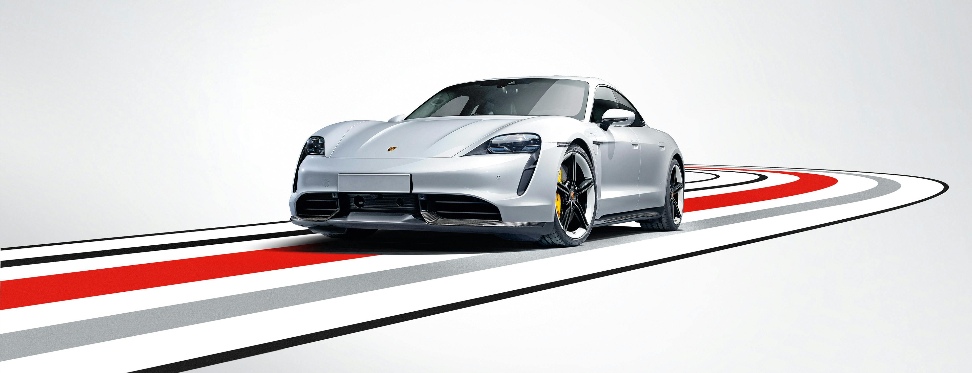 Porsche whistleblower system: A Porsche Taycan Turbo S driving around a bend toward us.