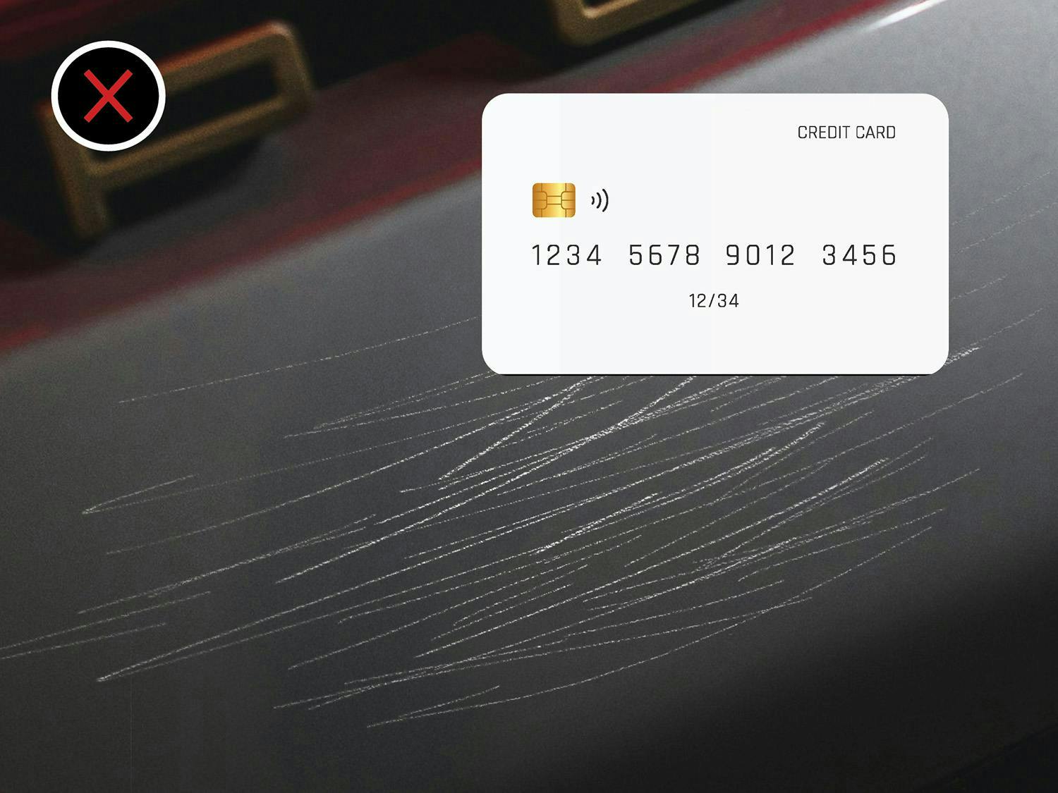 Credit card on a scratched red surface with an X mark indicating damage.