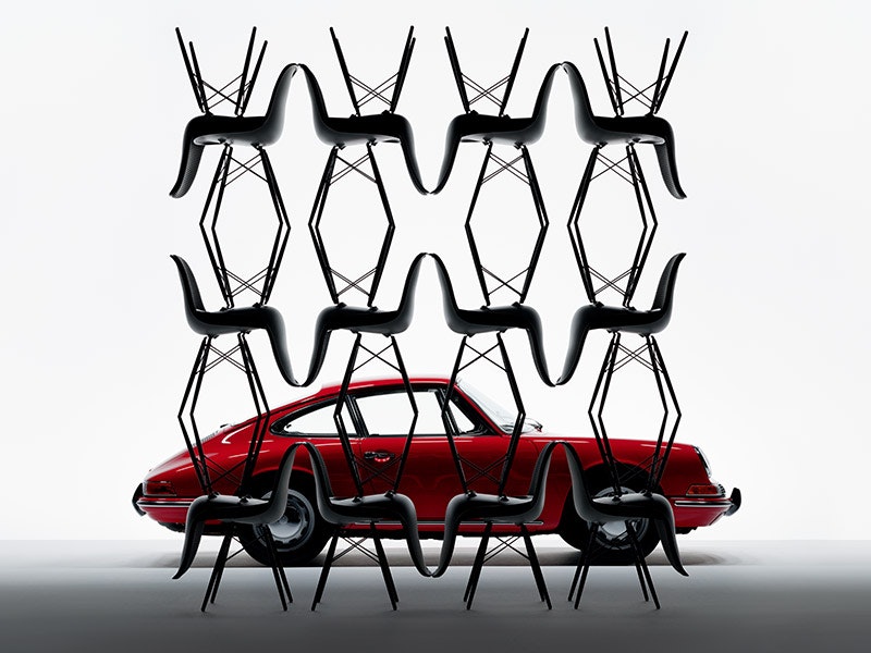 Stacked chairs in front of a vibrant red Porsche, fabric close-ups, chairs arranged in rows with moving shadows, one elongated.