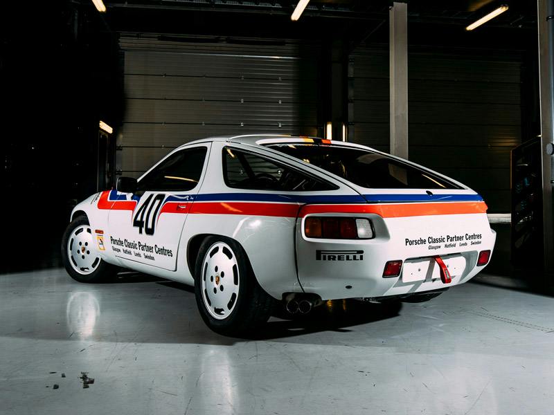 The Porsche 928 standing in a hall showing its rear.