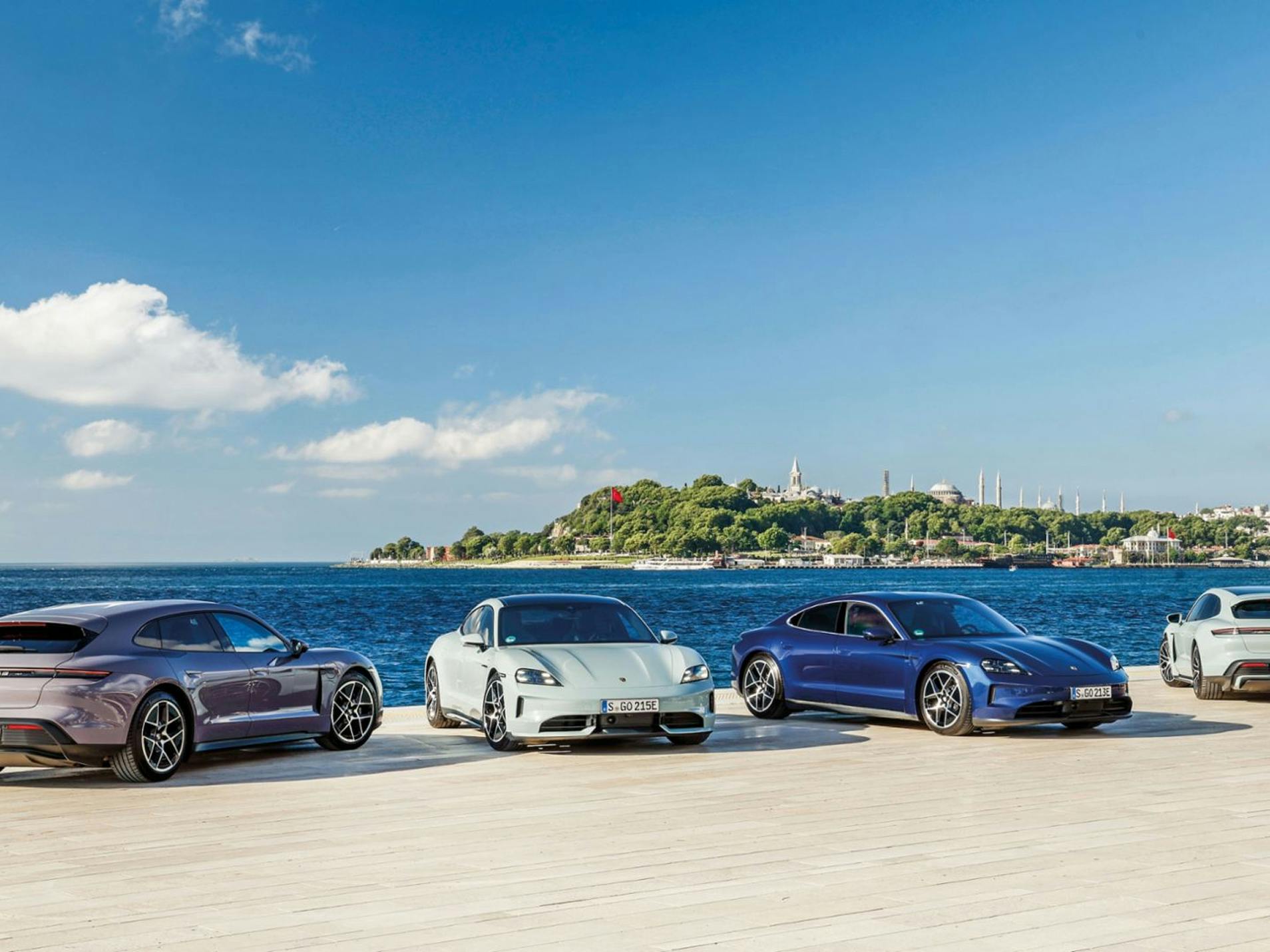 Four different Porsche Taycan models parked on the coast near Istanbul.