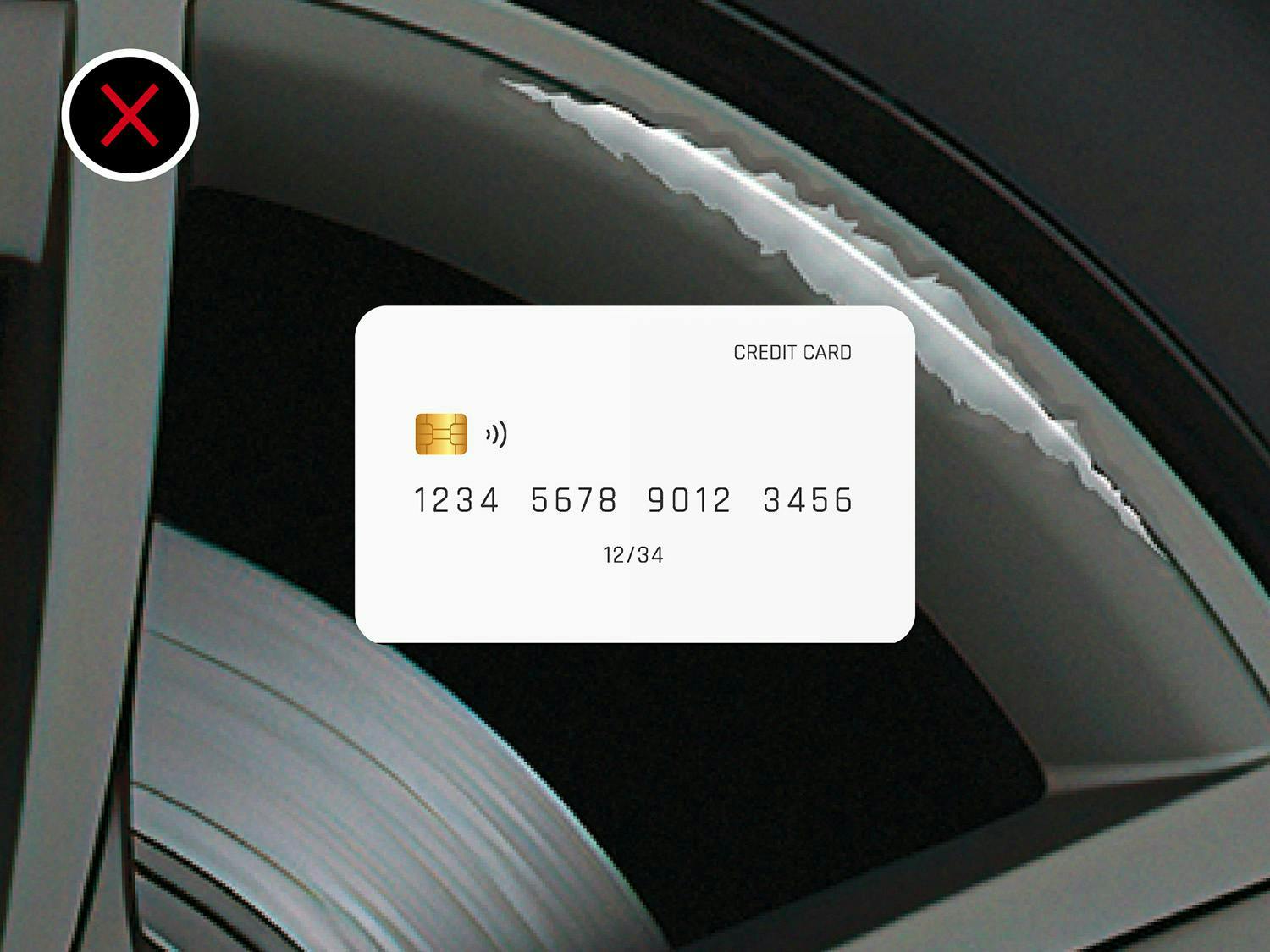 Credit card on a scratched black wheel with an X mark, indicating damage.