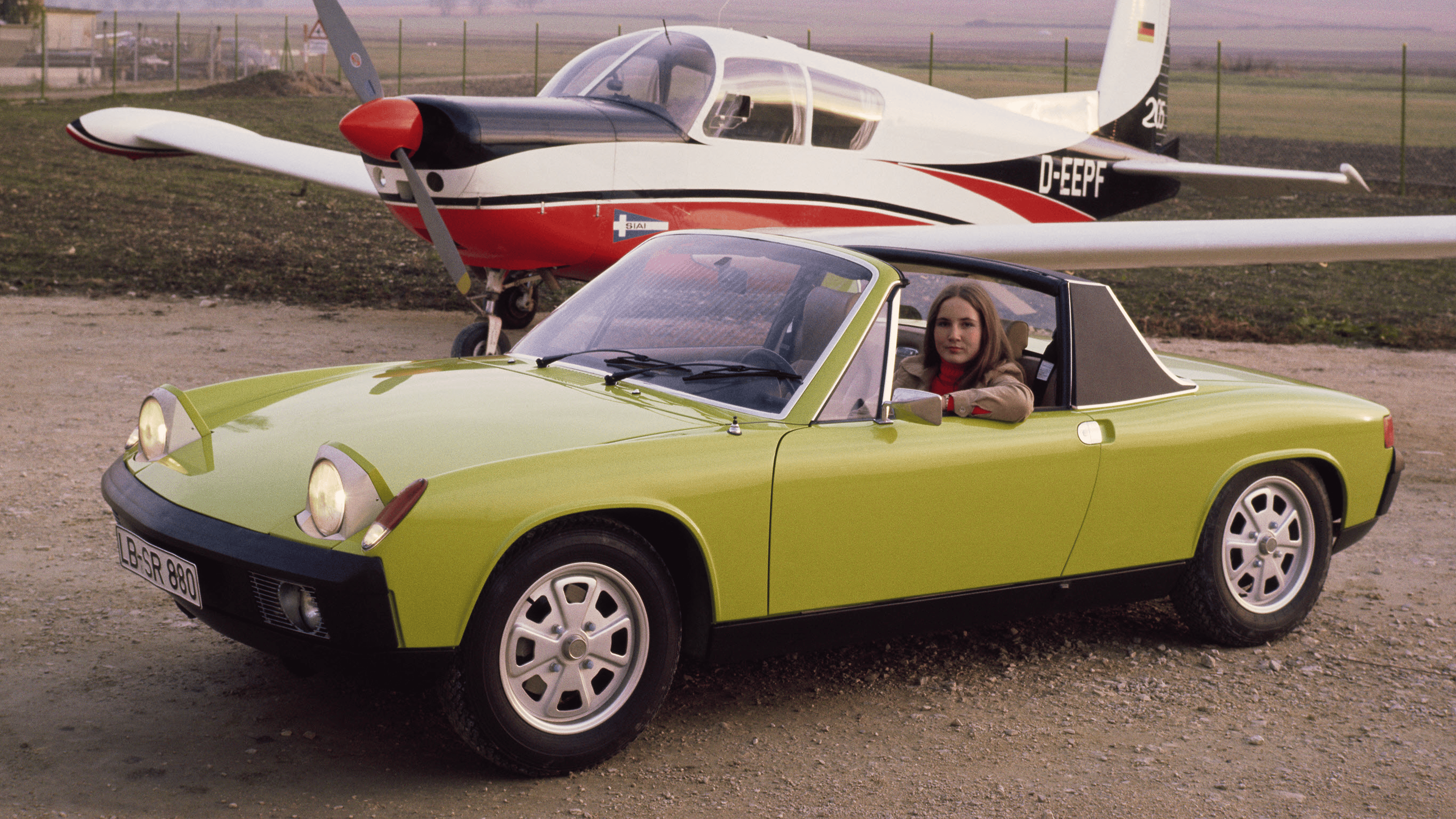 Porsche 914 in light green standing on an airfield