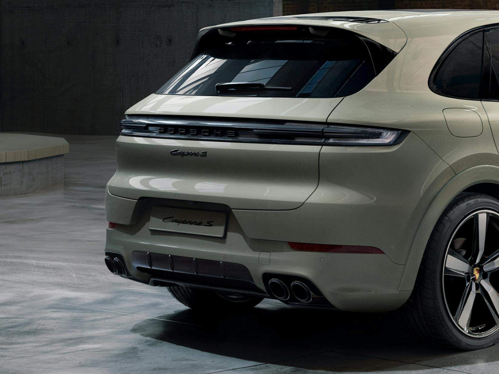 Porsche Exclusive Manufaktur Cayenne S in Geysergreymetallic in a hall. View of rear end.