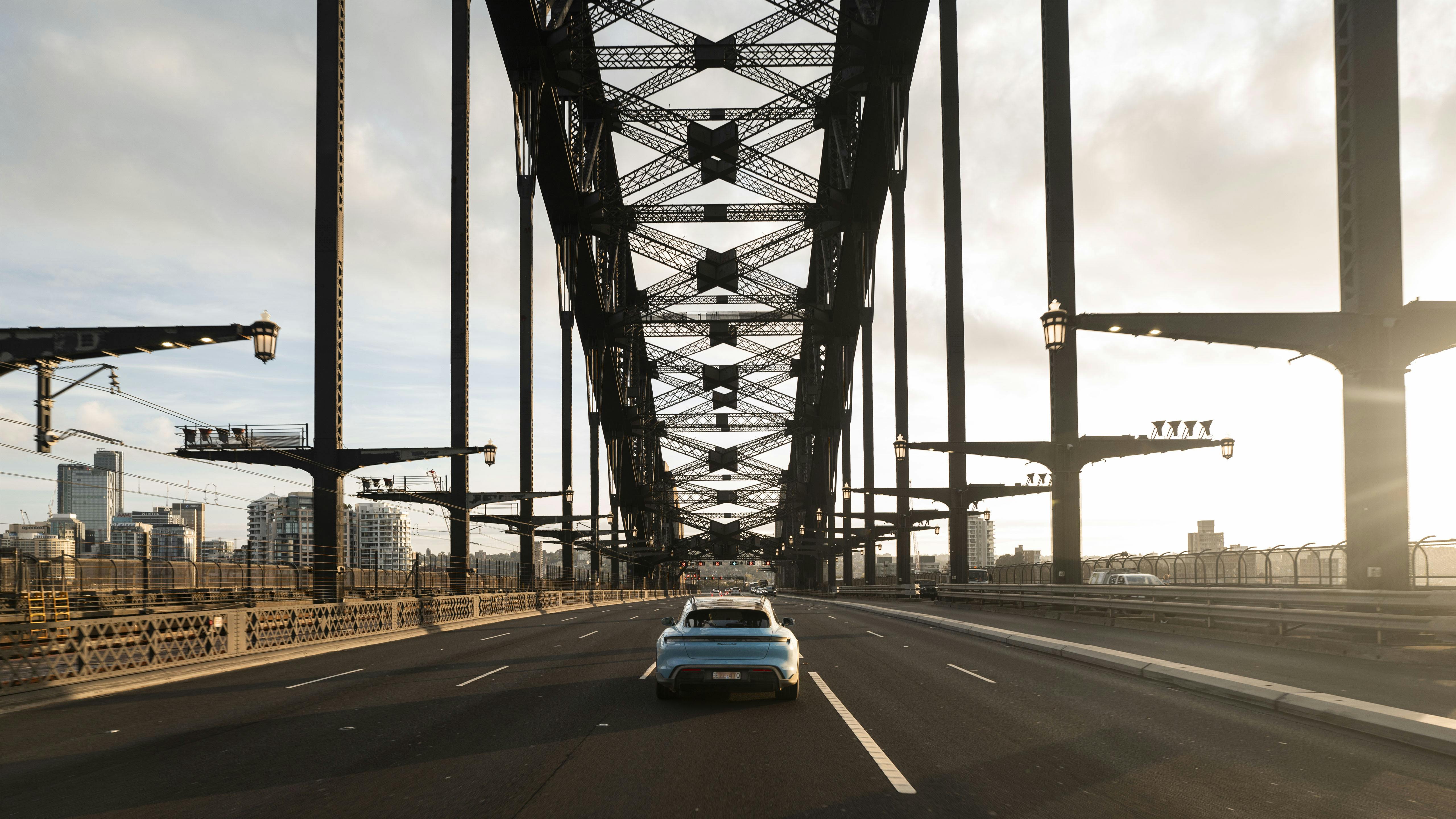 Porsche Taycan driving on very large bridge