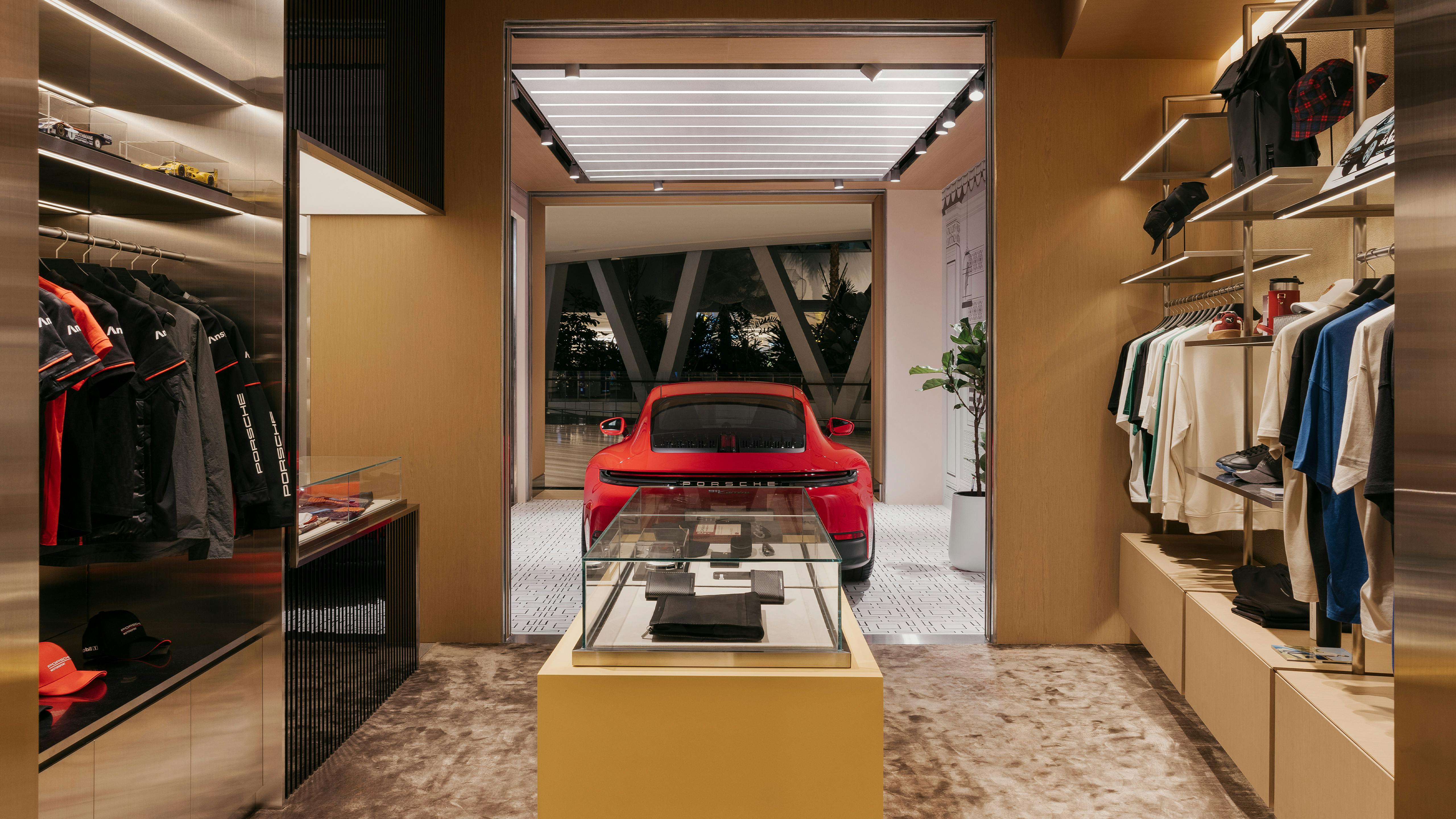 Porsche Lifestyle Boutique space lined with products, leading into the Porsche Culture Garage