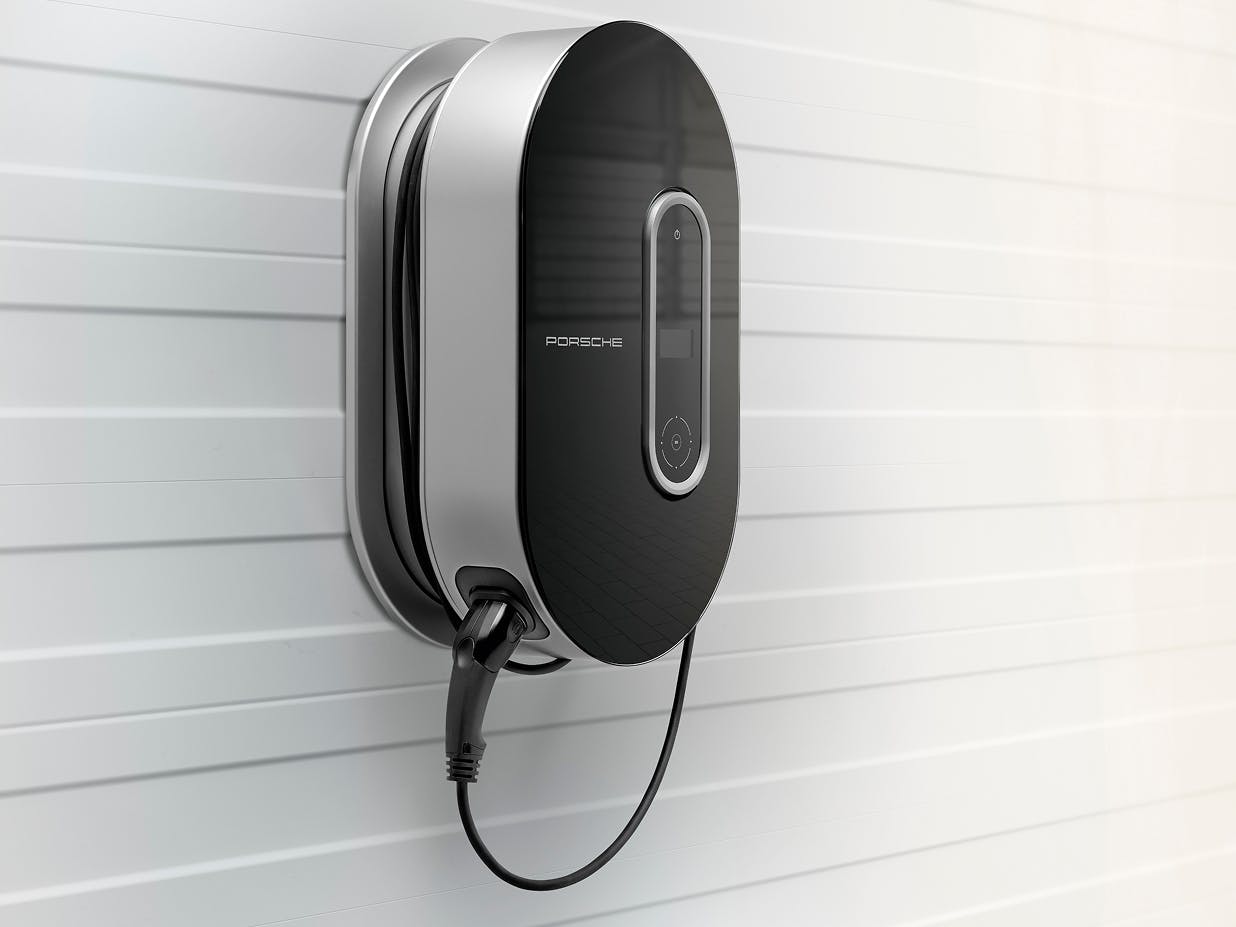 The Porsche Charging Dock mounted on a light grey wall.