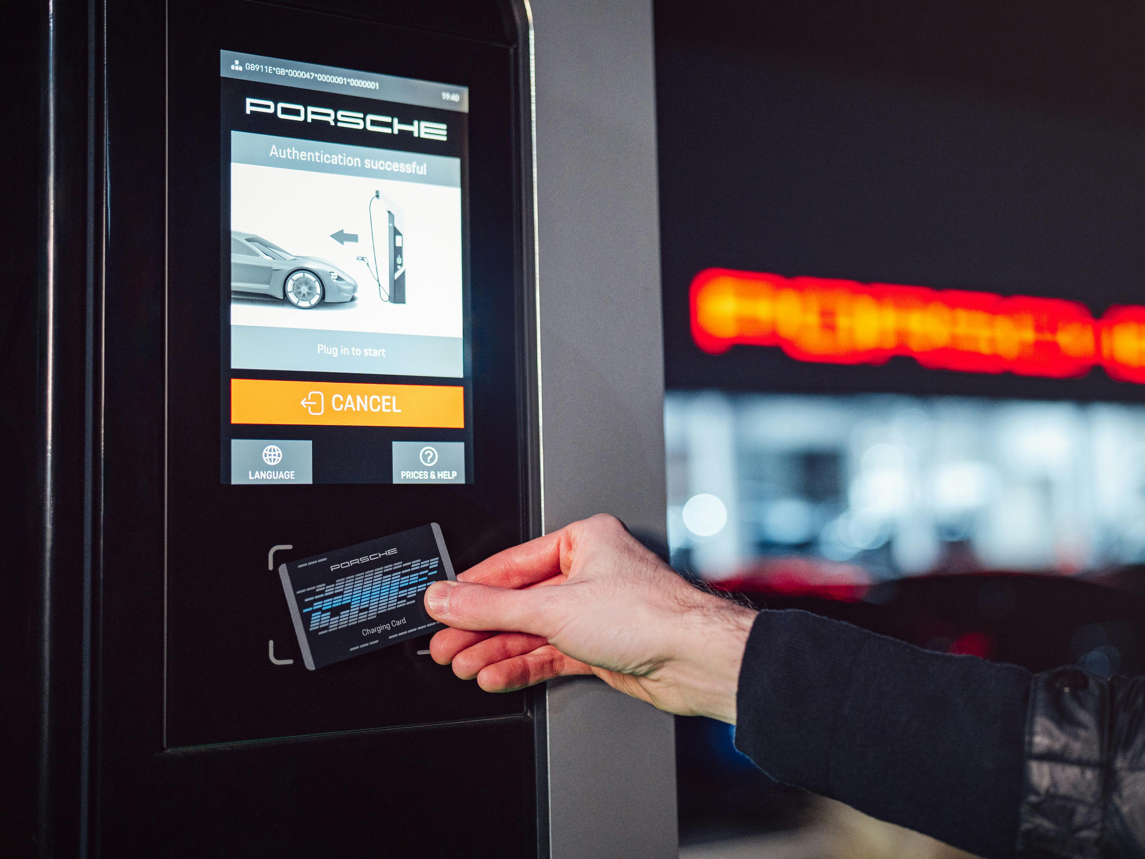 A Porsche owner tapping their Porsche Charging Service card on the charger to start the charging process.