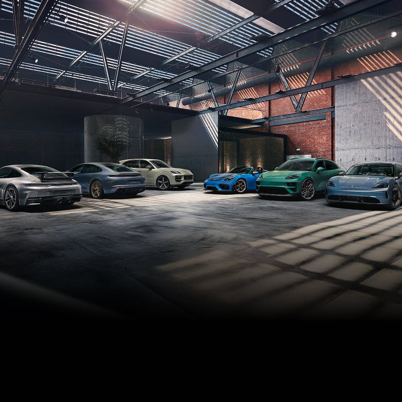 Various Porsche models next to each other in a warehouse.