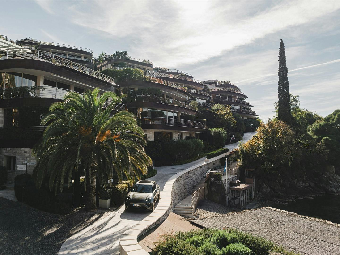 Porsche Macan driving on curved driveway in Budva at the Dukley Hotel & Resort.