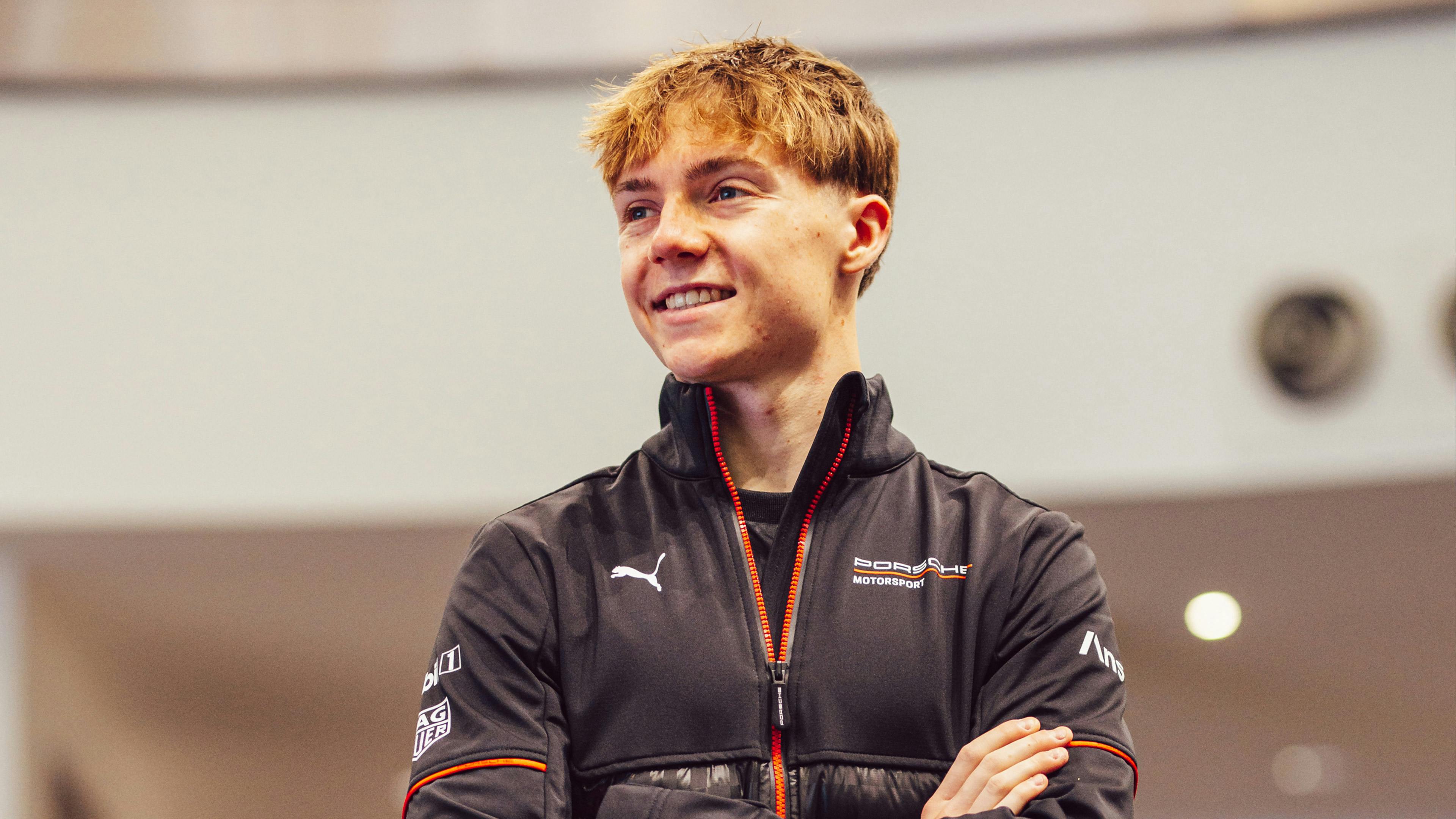 Callum Voisin, the official 2026–2027 RAFA Racing Club Porsche Carrera Cup GB Junior Driver, smiling with arms crossed.