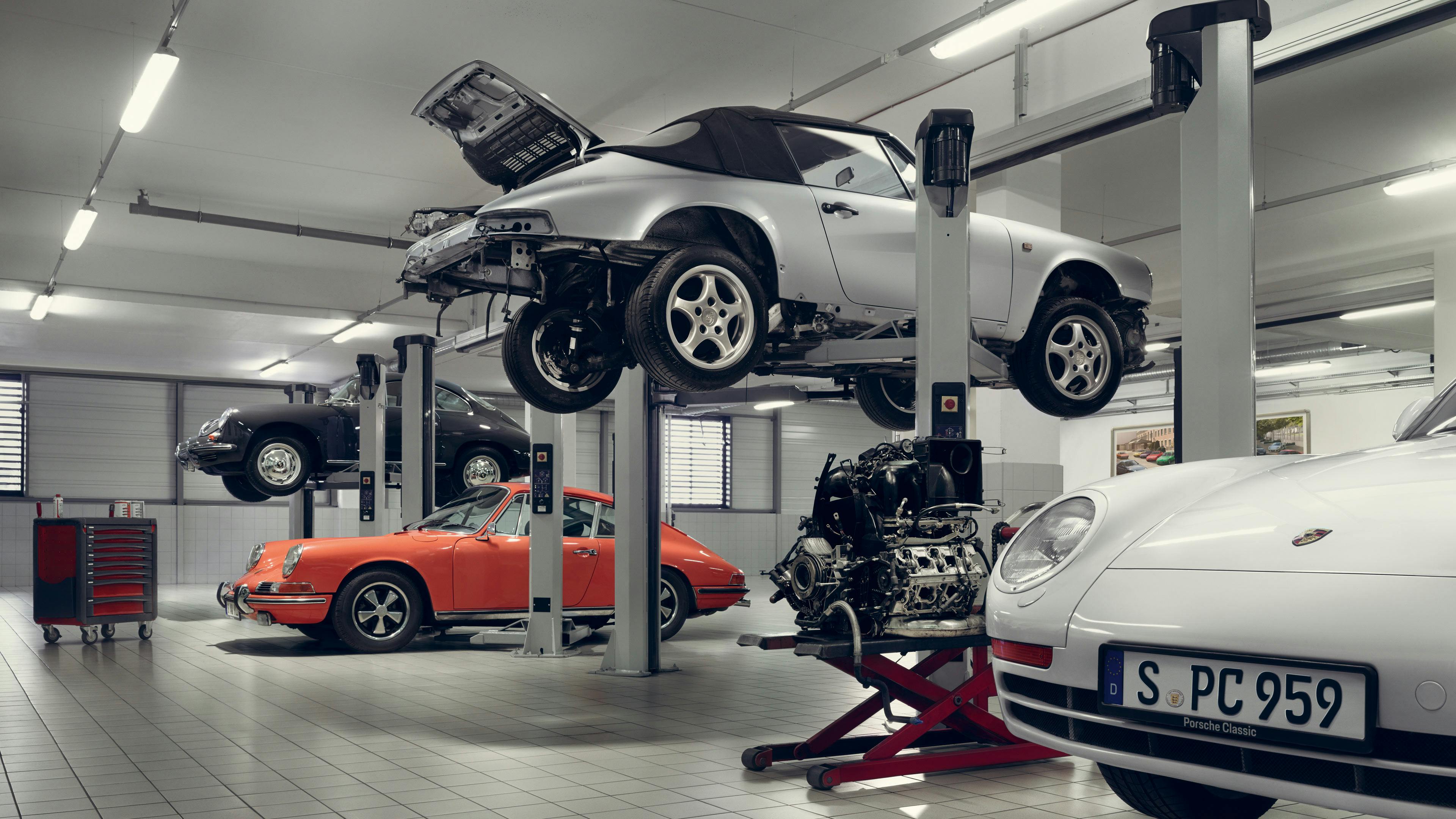 Showroom with elevated Grey Metallic classic Porsche car.