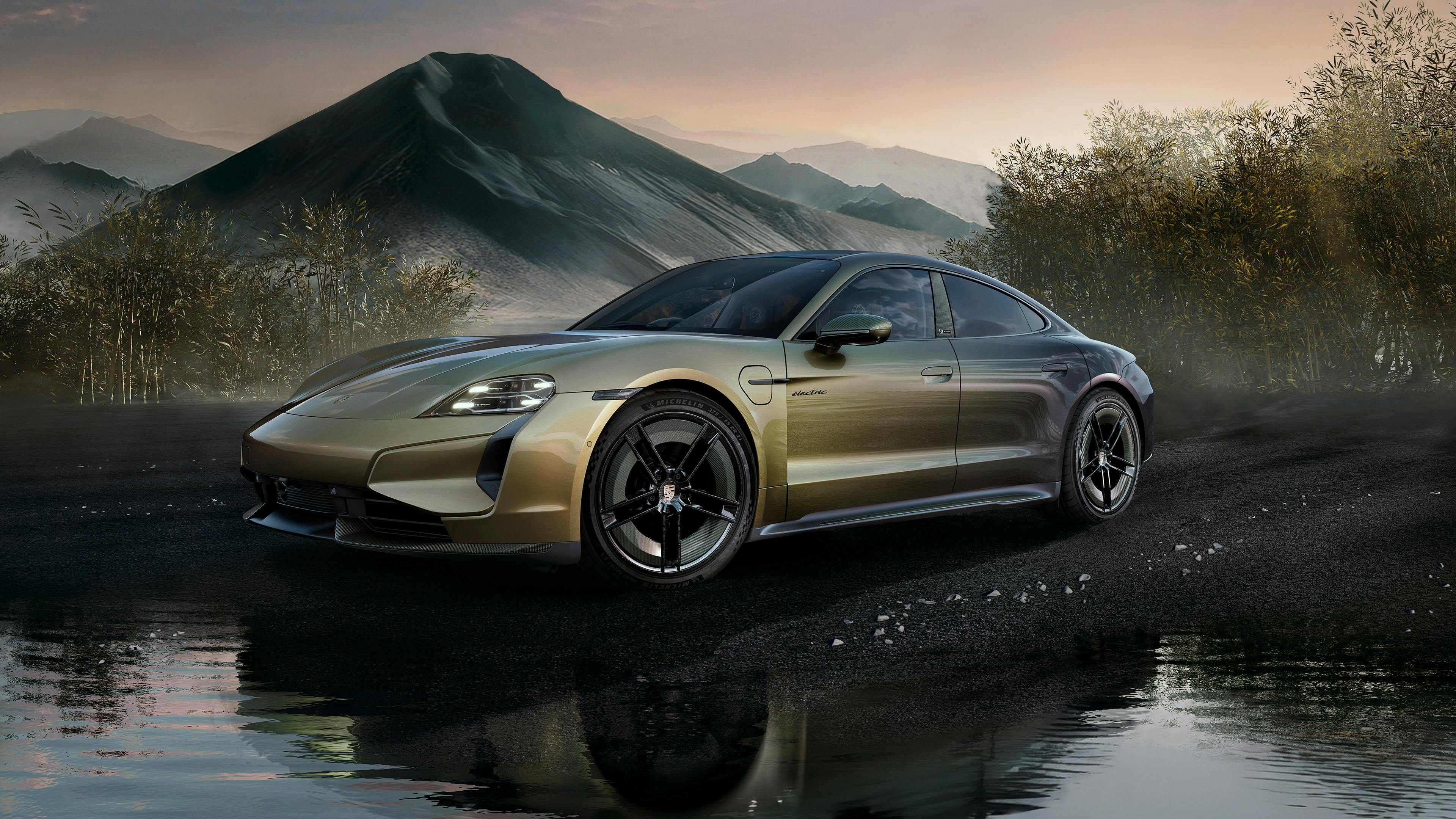 A Taycan Turbo S Celestial Jade in individual colour Urban Bamboo Cromaflair, in front of a mountainrange at a lake.