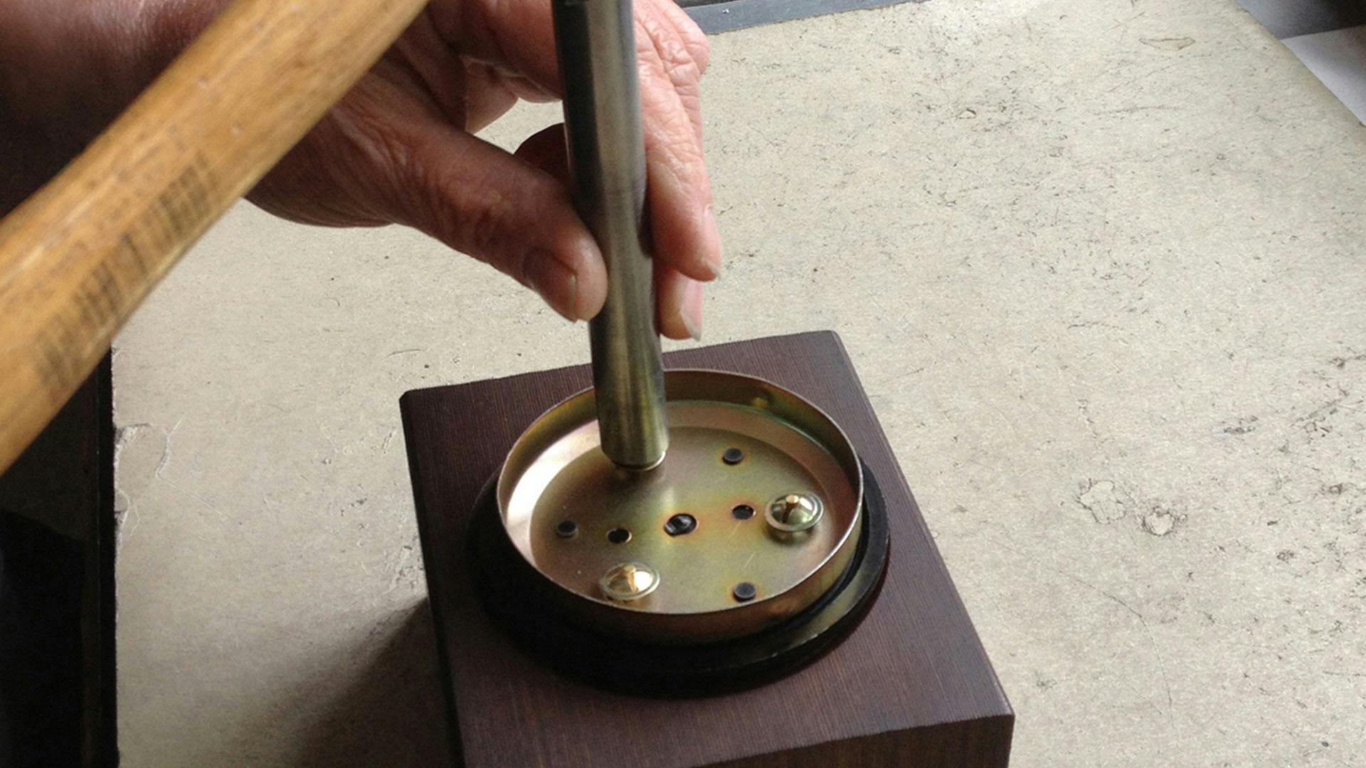 Hub caps being manufactured, three images