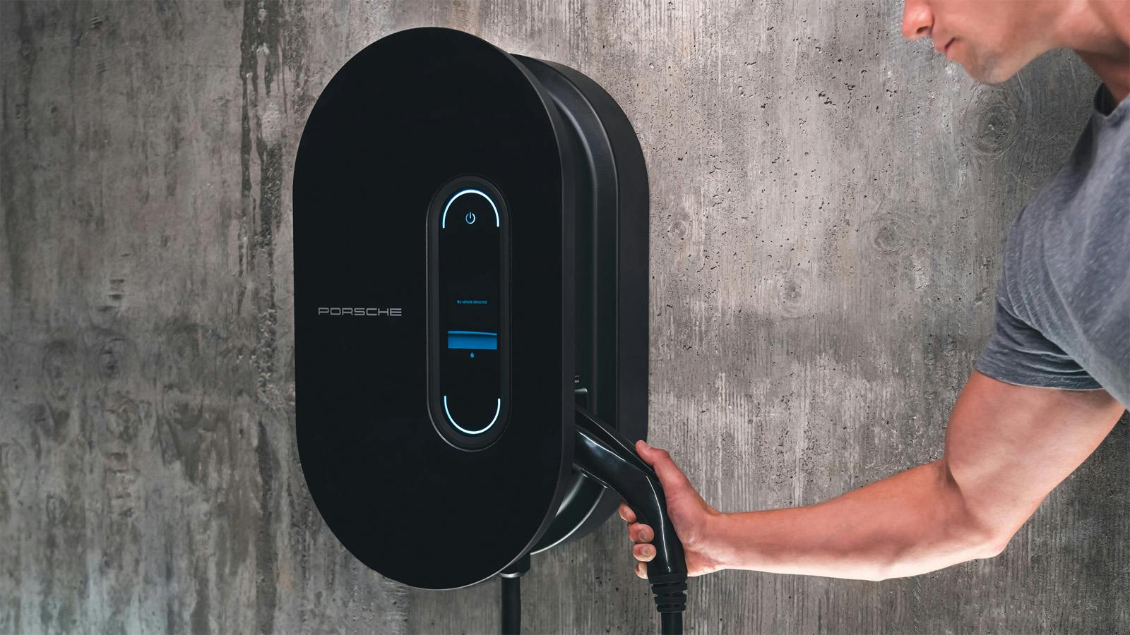 A customer charging their Porsche in their own garage with the Porsche charging hardware.