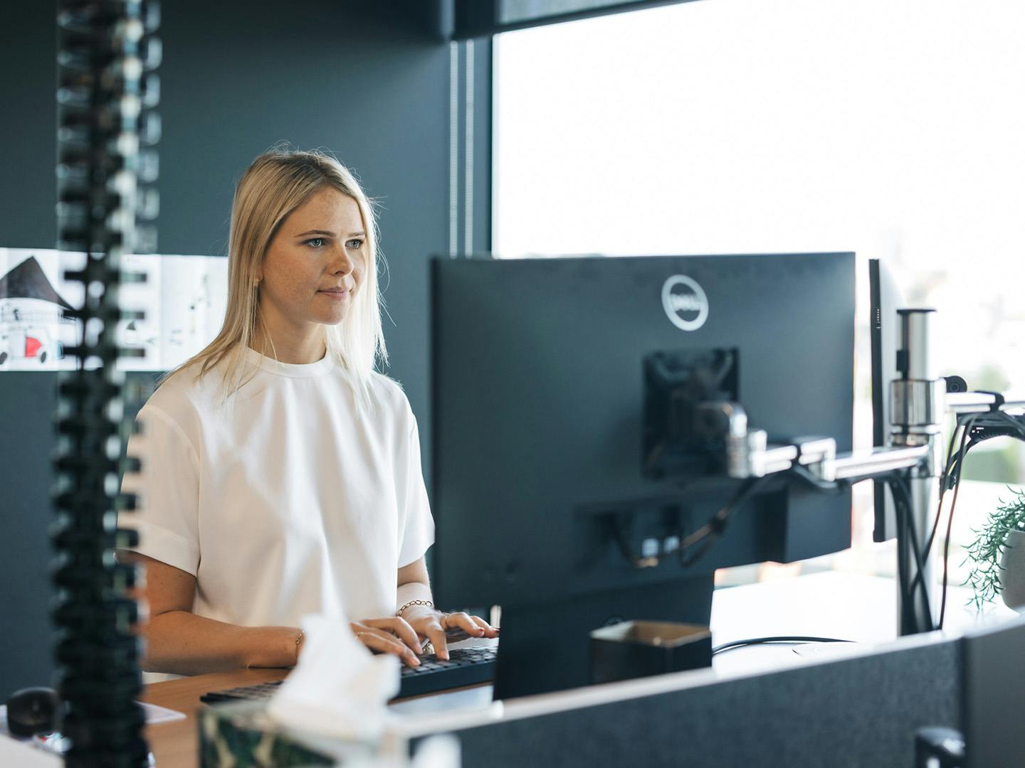 a woman standing infront of a computer