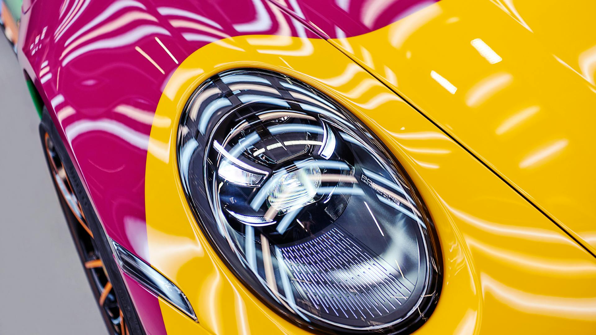 Dreams in Colours: Close-up of a headlight from a Porsche 911 model.