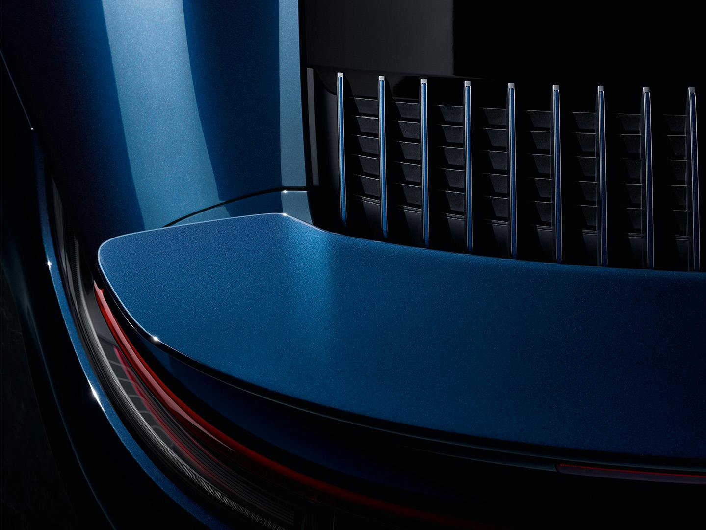 Close-up of a blue Porsche car's sleek design, showcasing a glossy surface with red accents and grille details in modern, aerodynamic styling.