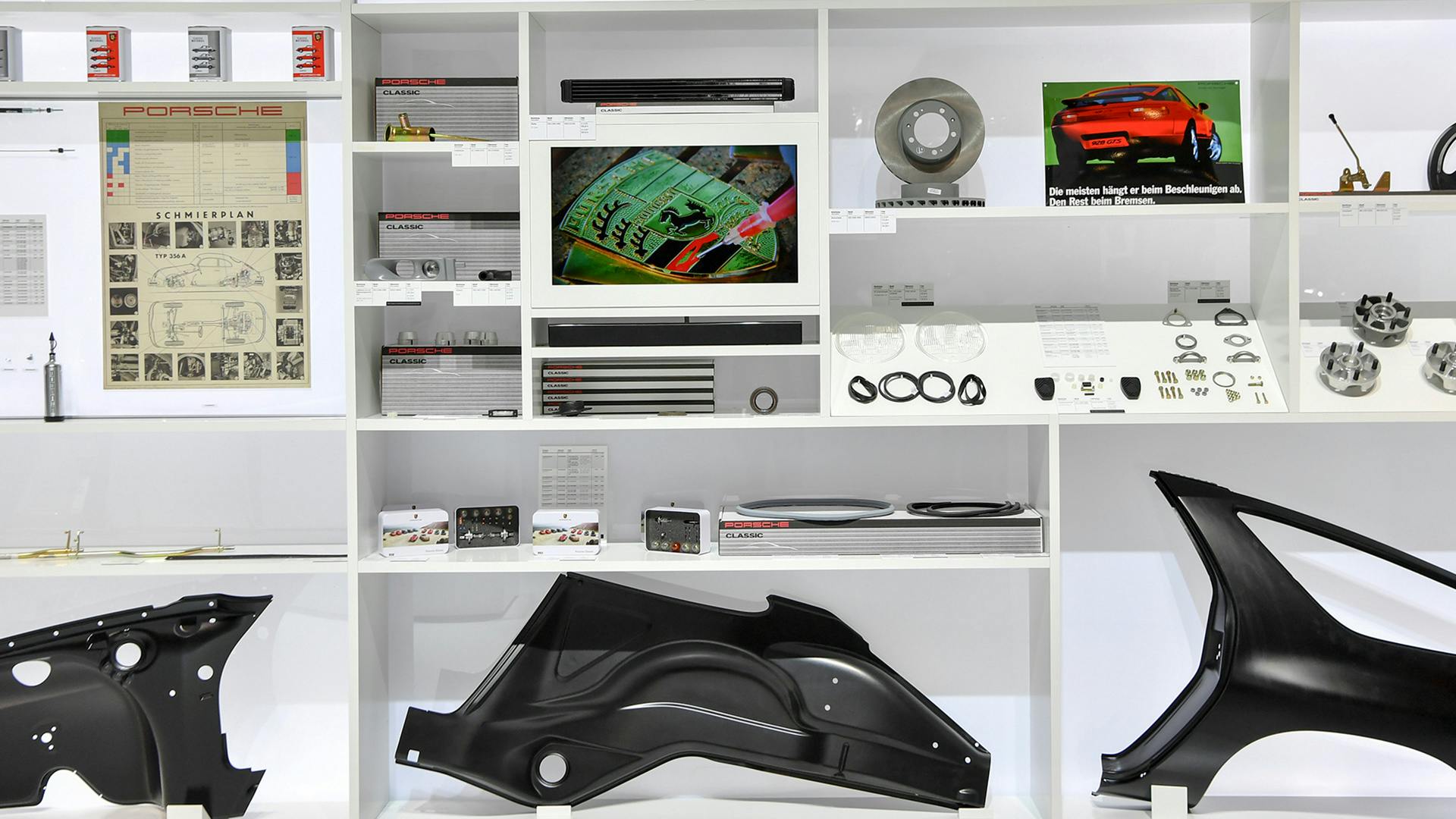 Porsche accessories and spare parts on shelves.
