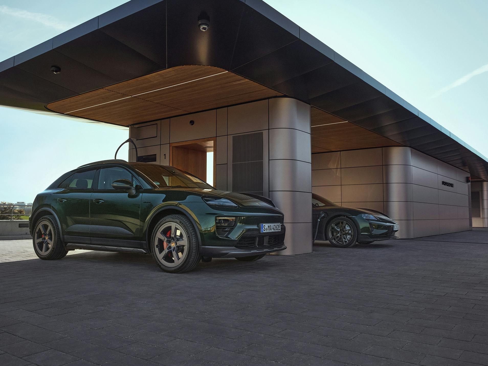 A Porsche Macan 4S and a Porsche Taycan Turbo Cross Turismo charging at a Porsche Charging Lounge.