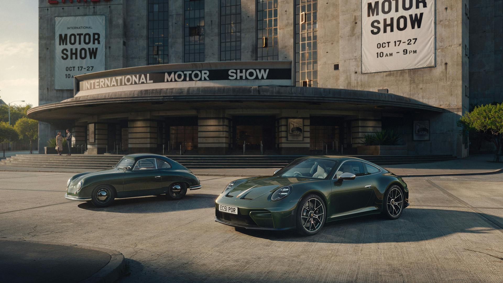 A classic Porsche 356 and the new Earls Court 51 Edition 911 parked side by side outside the Earls Court Motor Show building.​