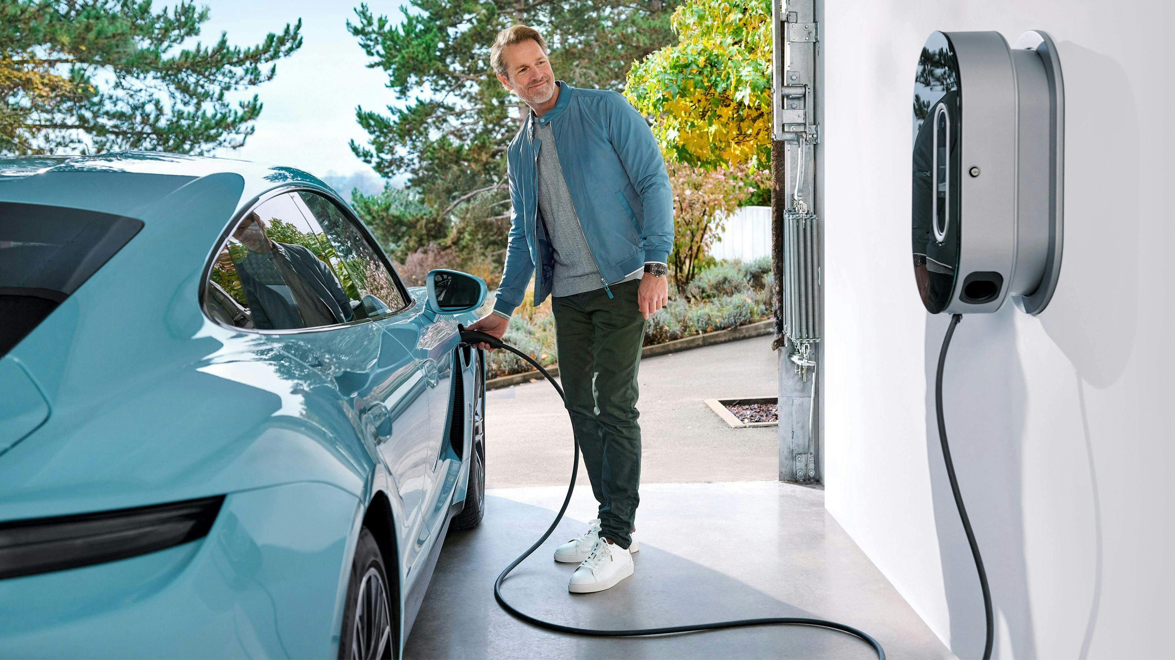 A customer charging their Porsche in their own garage with the Porsche charging hardware.