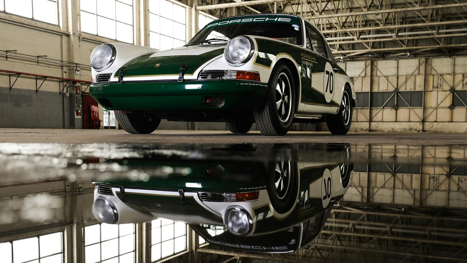 The ‘Project 70’ 911 standing in front of a puddle in an abandoned hall.