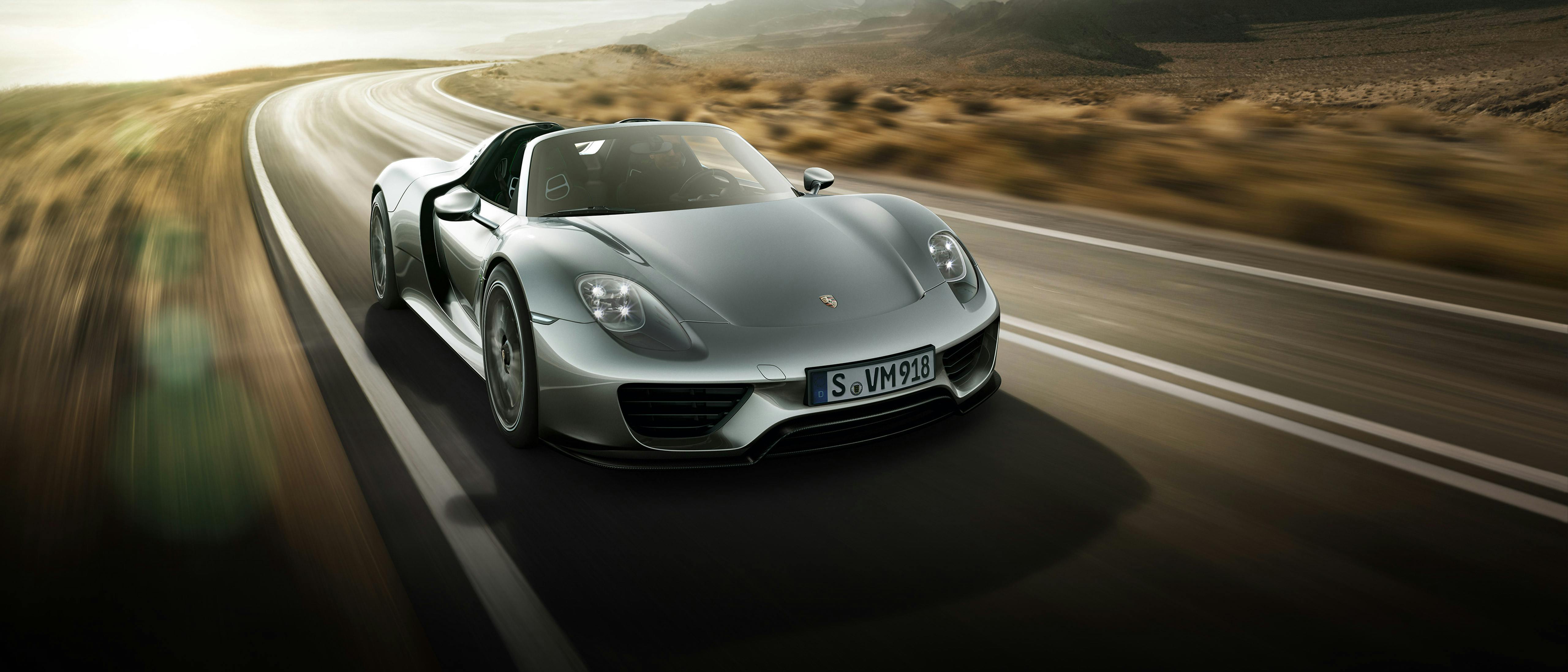 918 Spyder driving through a mountain landscape