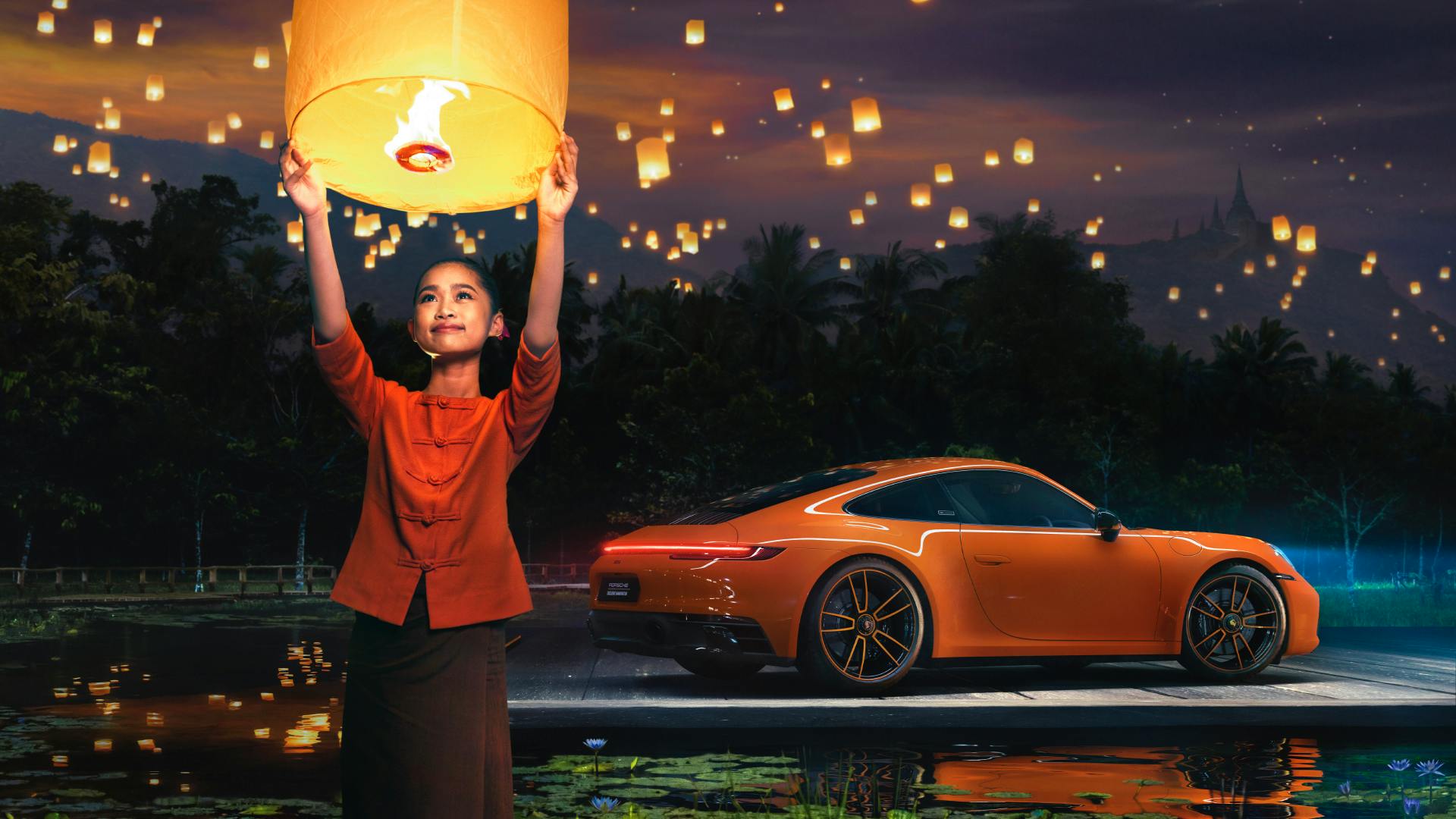 Dreams in Colours: Pastelorange 911 model drives at night along a street, a woman releases a light balloon in the sky.