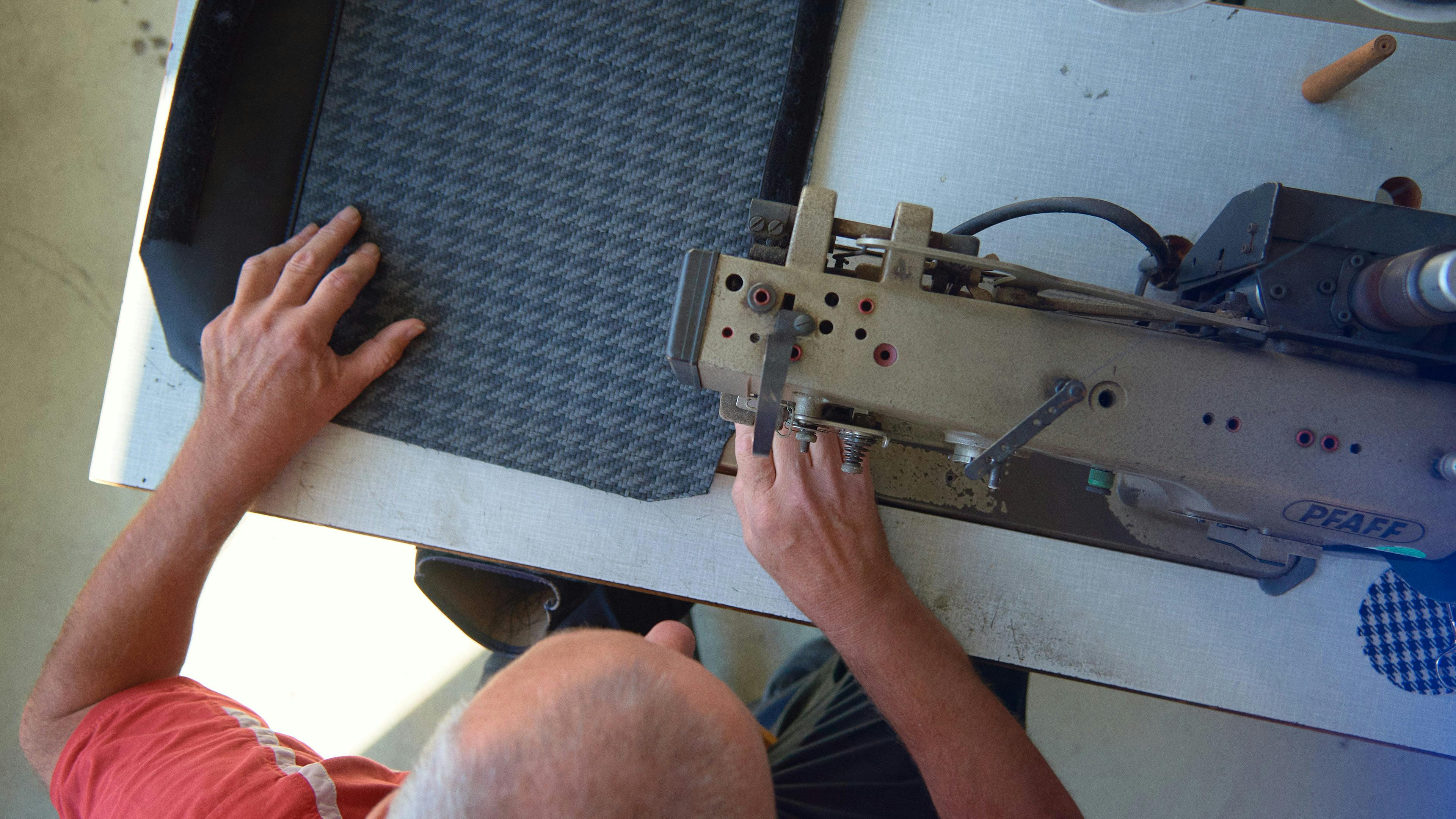 Upholsterer sews the seat covers of the 911 Classic Club Coupe.