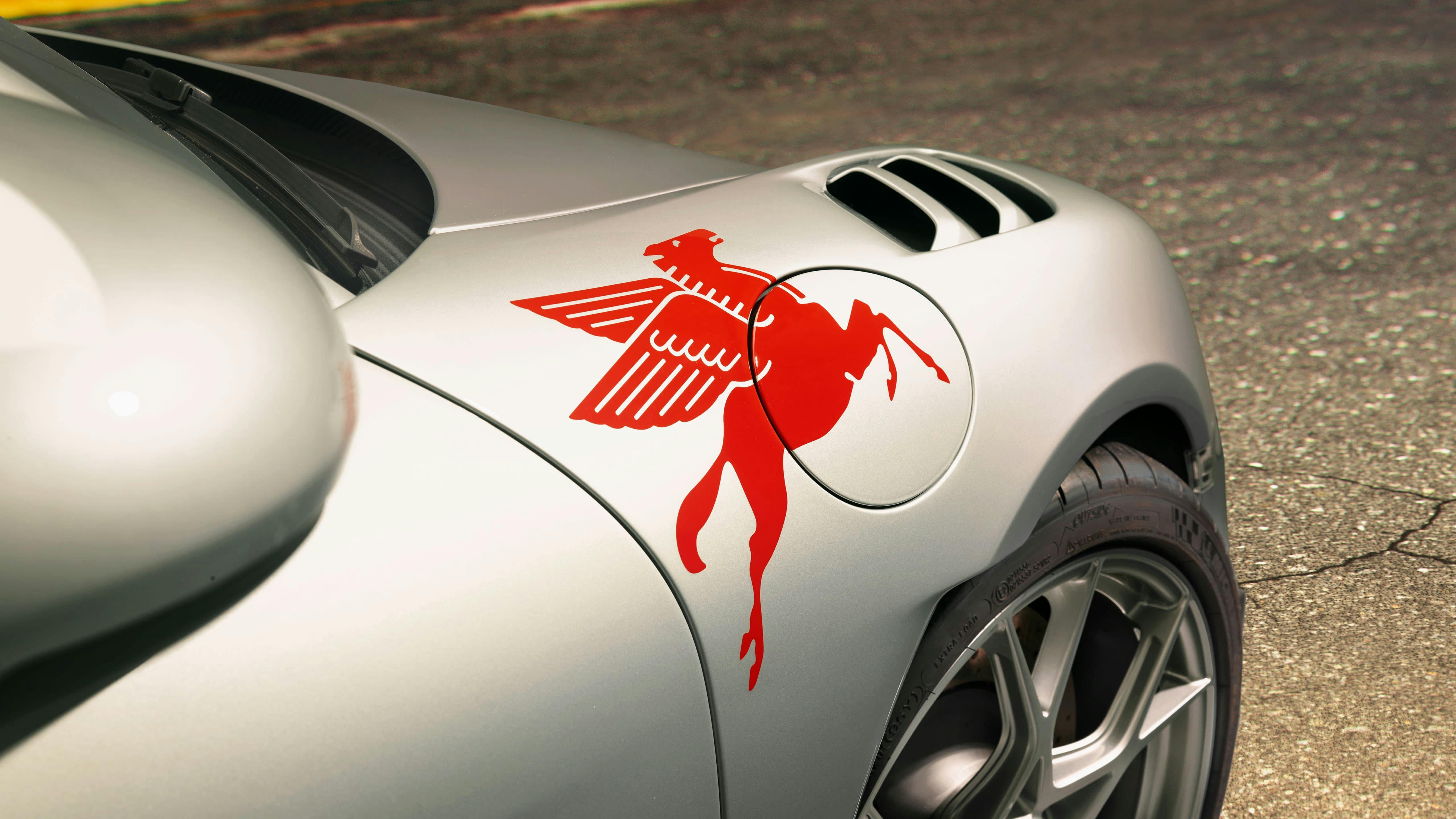A pegasus resting on the body of the car.