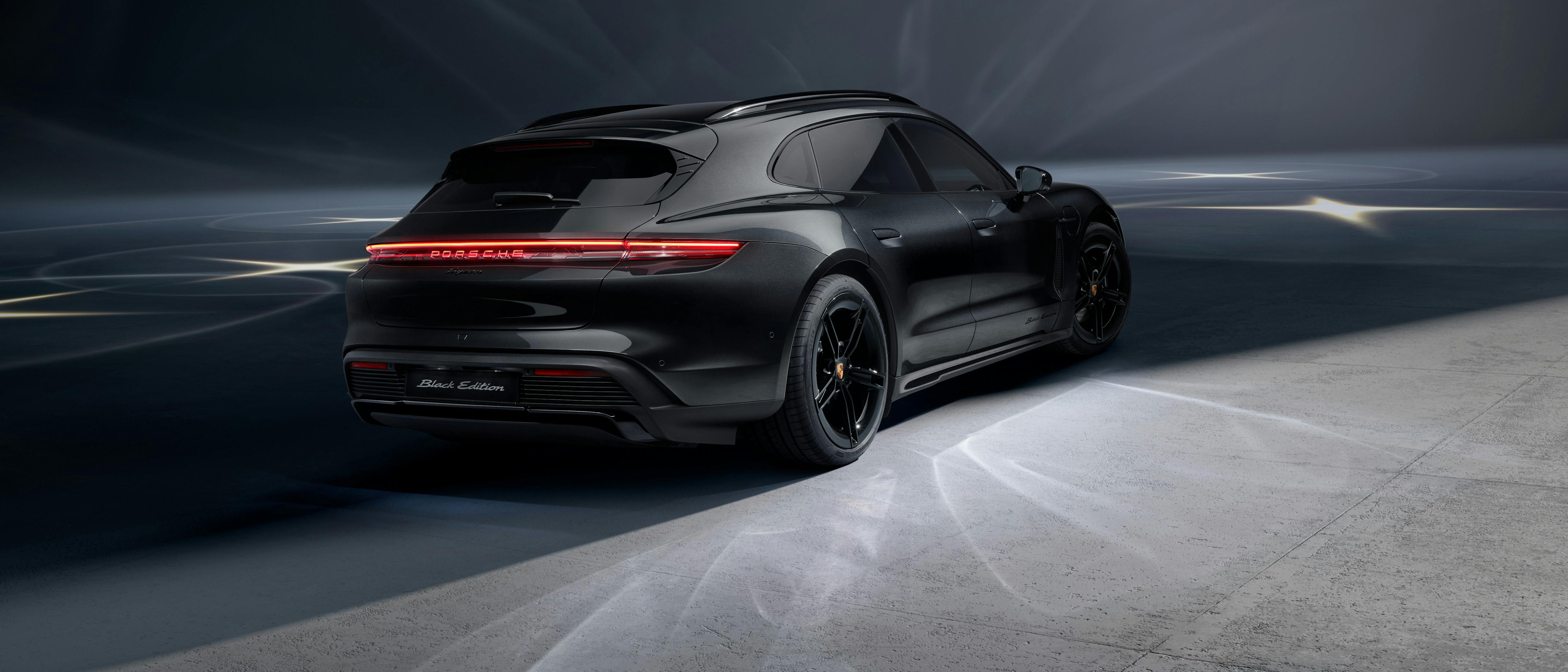 A rear view of the Taycan Sport Turismo Black Edition that is situated in a studio environment.