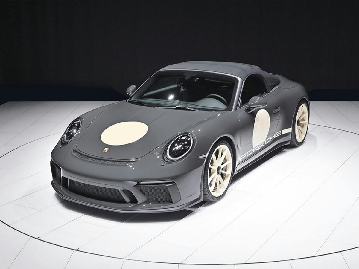 A Porsche 911 Speedster in Paint to Sample colour Slategrey6601, shown on a rotating studio platform.