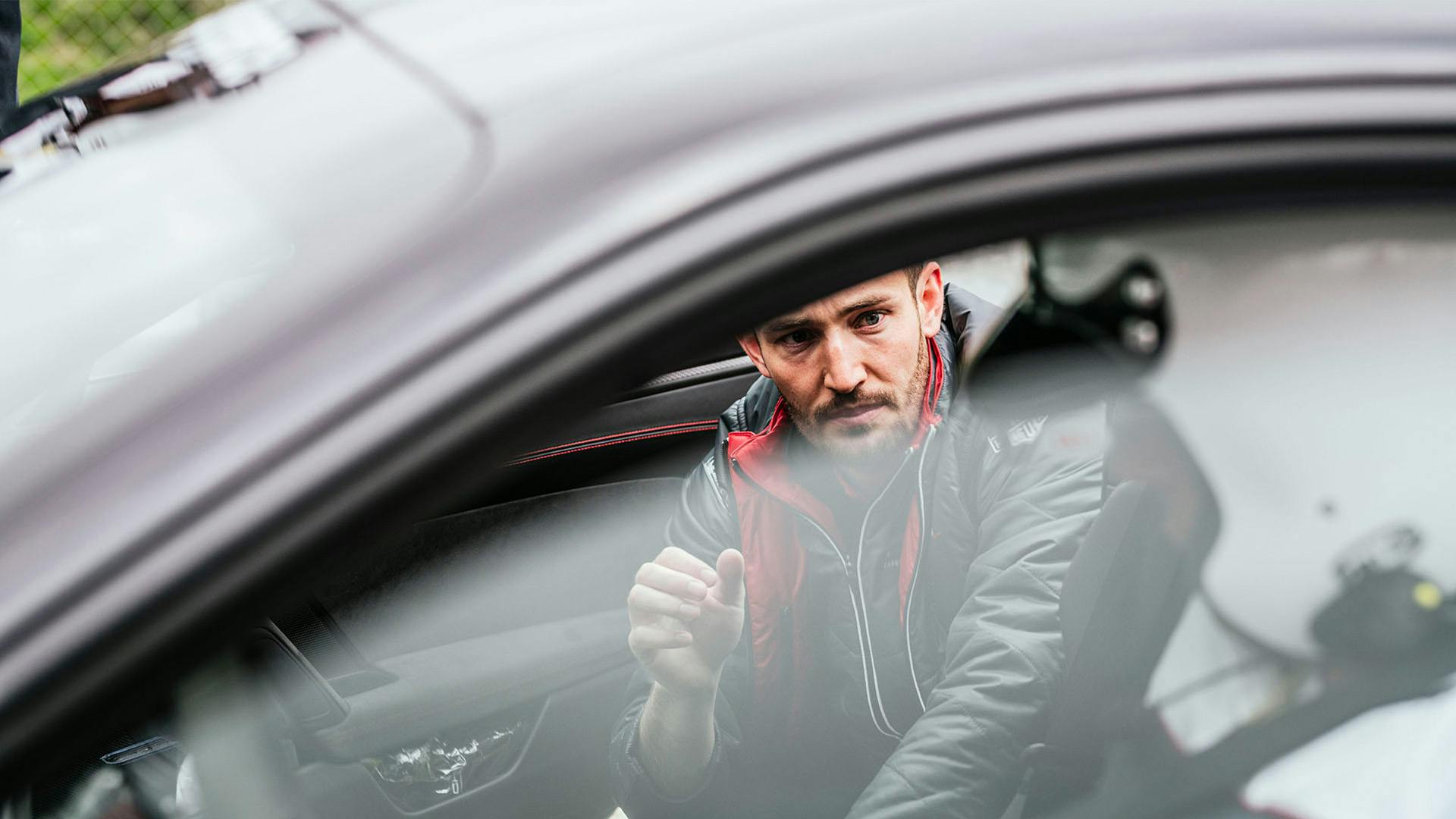 During the Porsche Track Experience, participants receive precise instructions from their instructor.