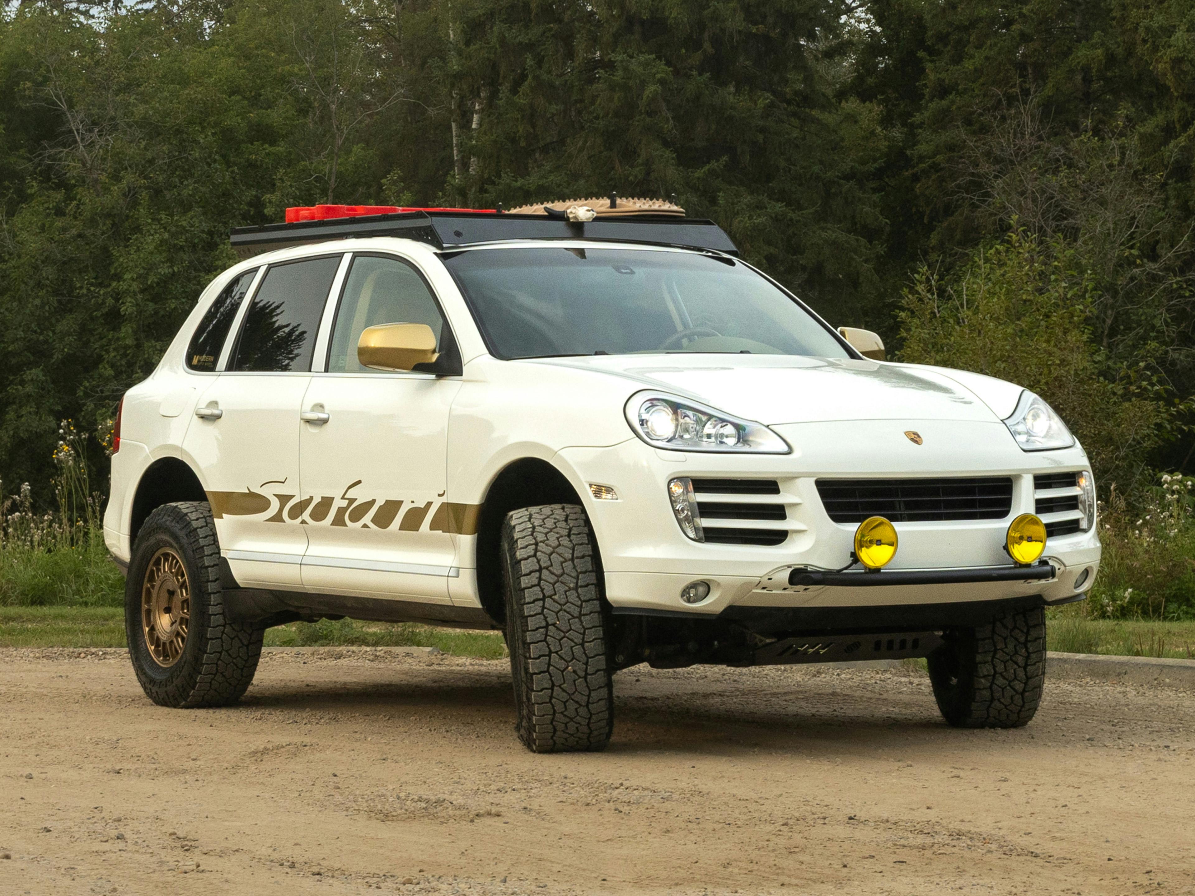 Edmonton – A white Porsche Cayenne parked in a parking lot with a black wall in the background.