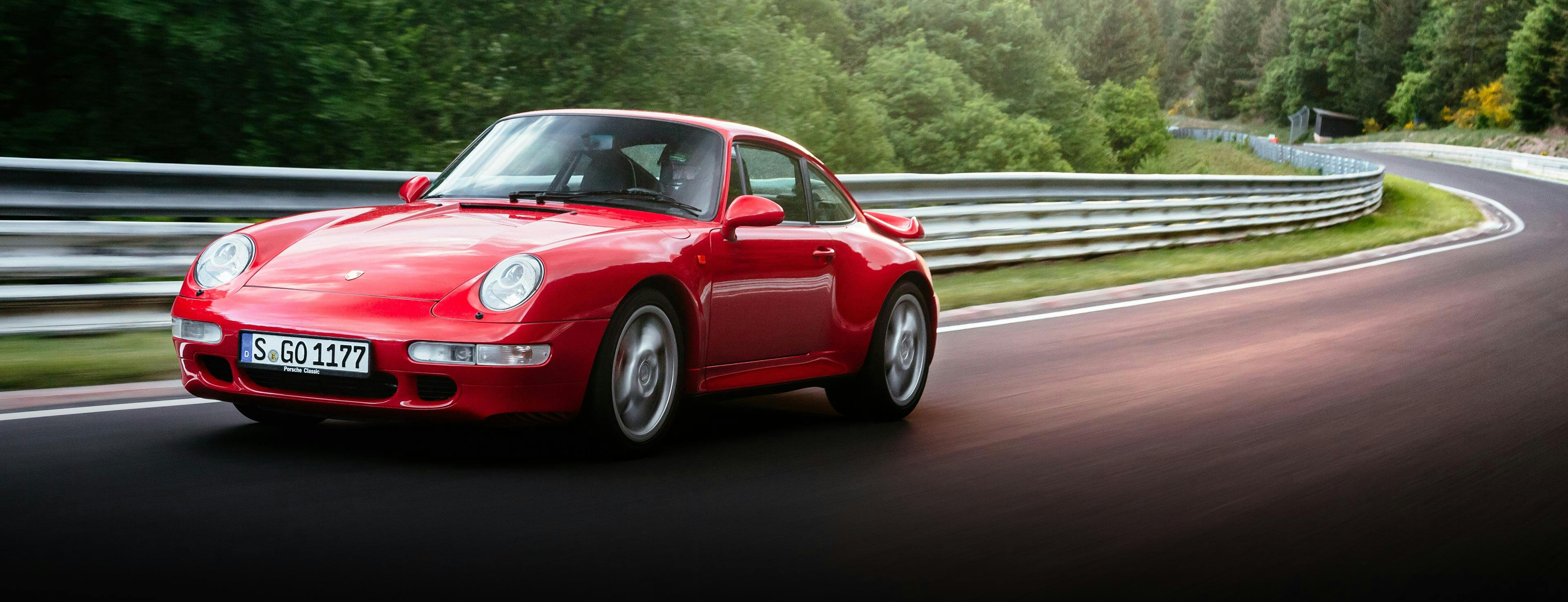 Red Porsche 993 in motion, street scene.