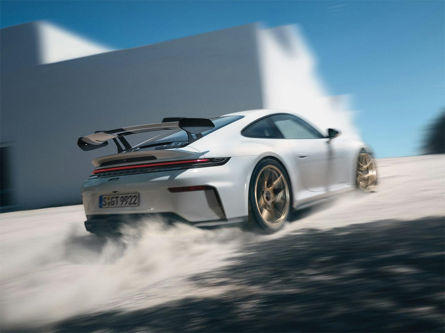 A back view of a white 911 GT3 with Weissach Package.