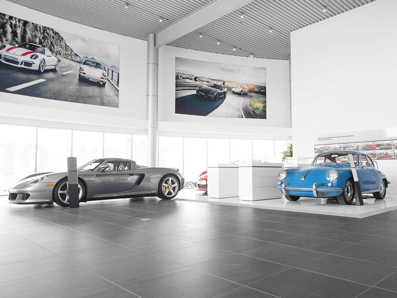 Une Carrera GT argentée et une Porsche 356 bleue à l'intérieur du Centre Porsche Vaughan