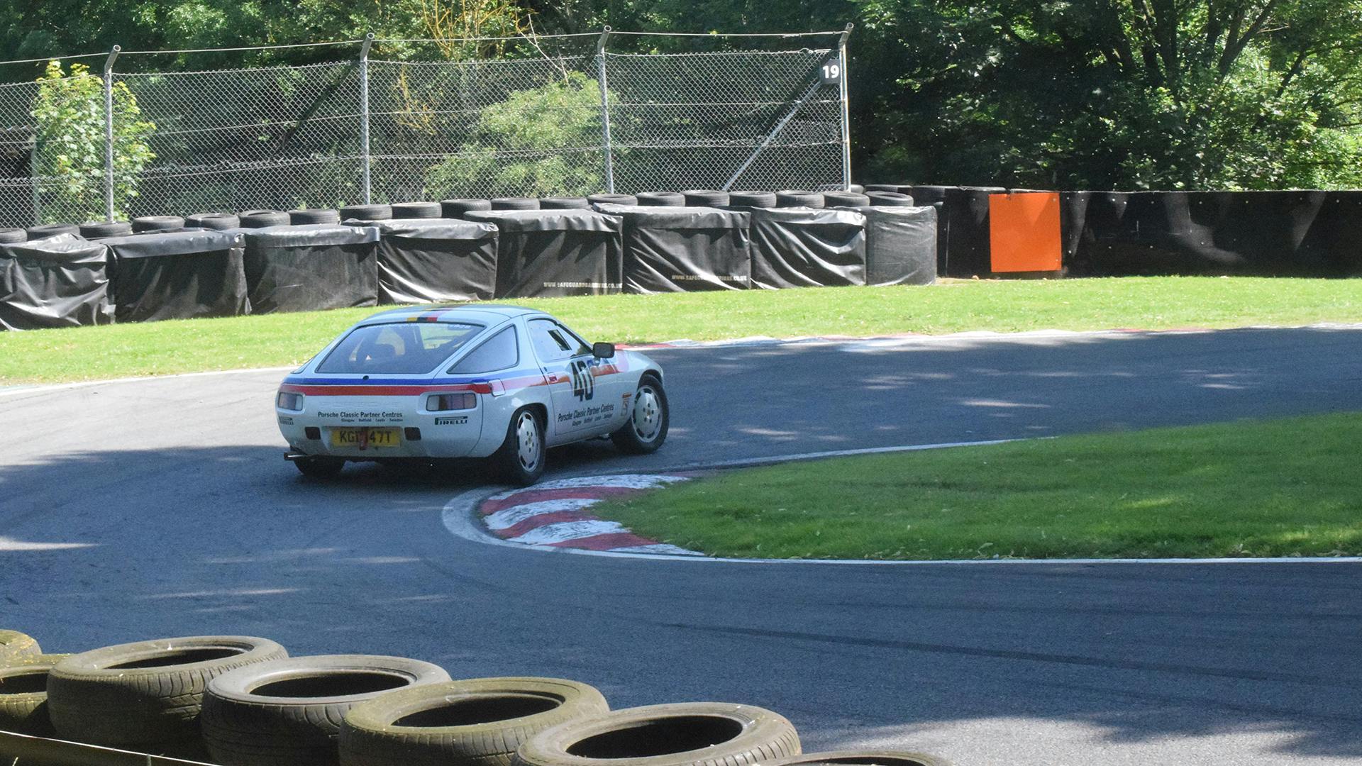 The Porsche 928 racing along the race track.