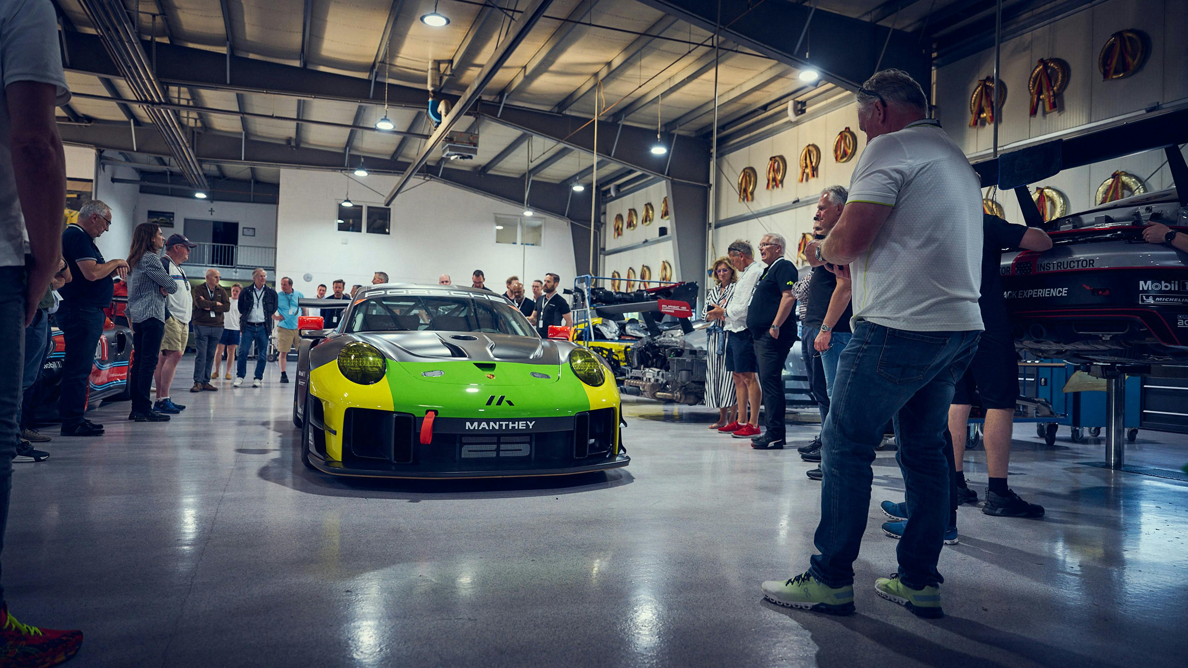 Porsche fans gathered in a garage