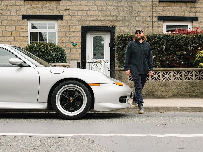 911 type 996 with black Fuchs rims in urban enviornment.